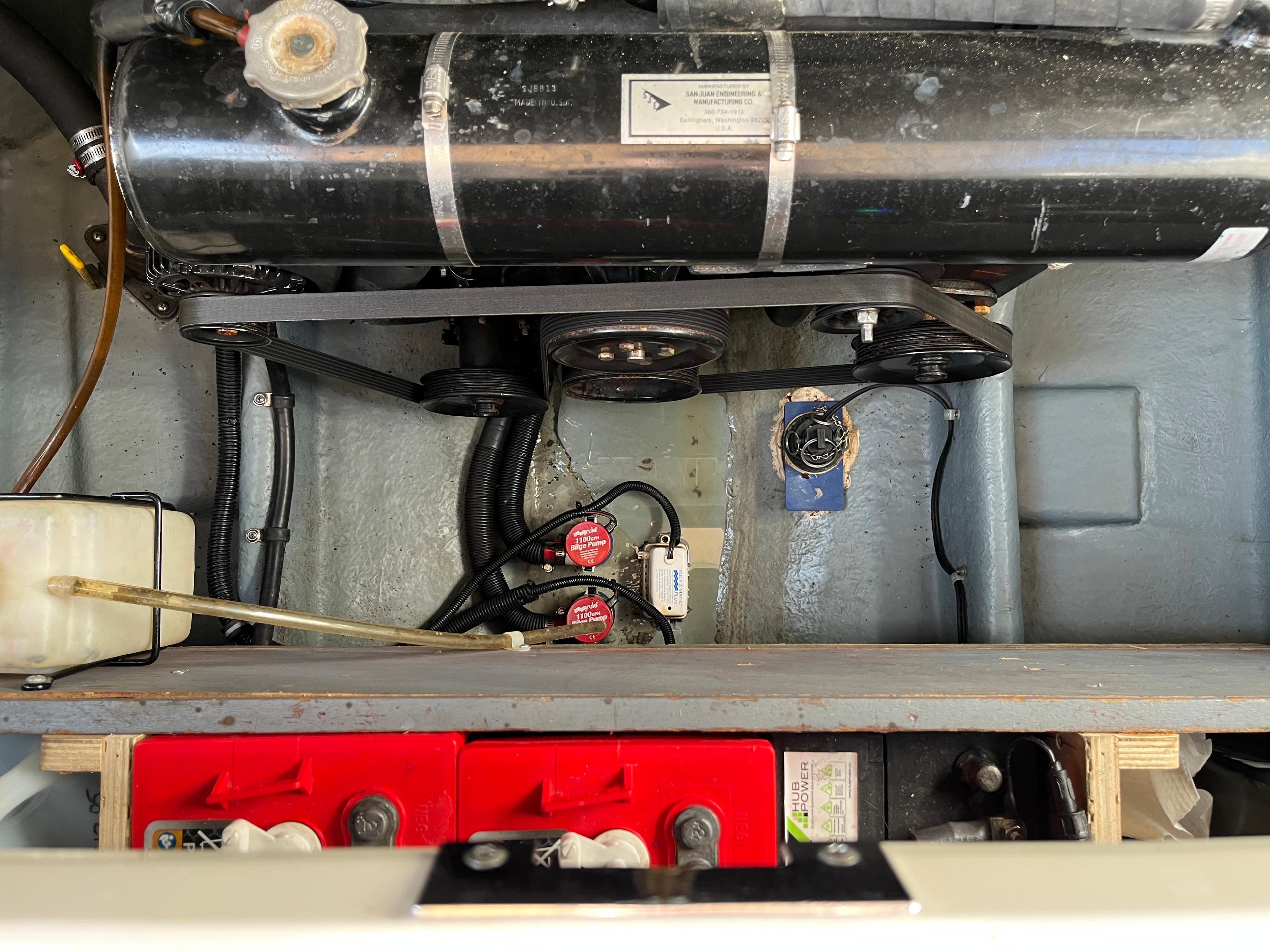Engine compartment of a 2001 Sea Ray 270 Sundancer boat, showing batteries and mechanical components.