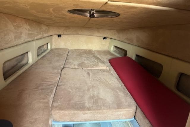 Interior cabin of 2008 FB Design Buzzi Rib 42 with beige and red cushions.