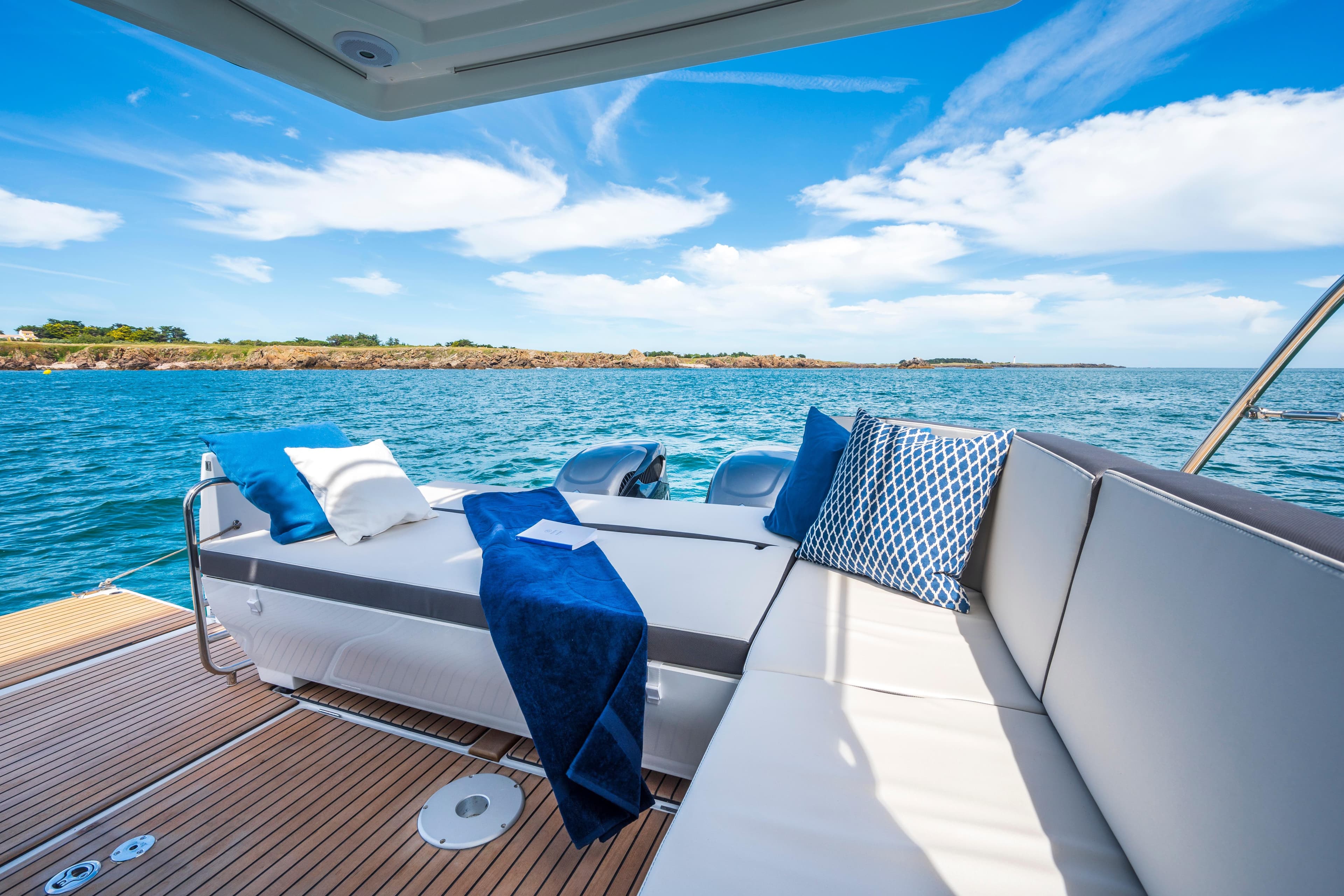 Luxurious 2026 Beneteau Antares 11 Coupe yacht interior with ocean view and plush seating.