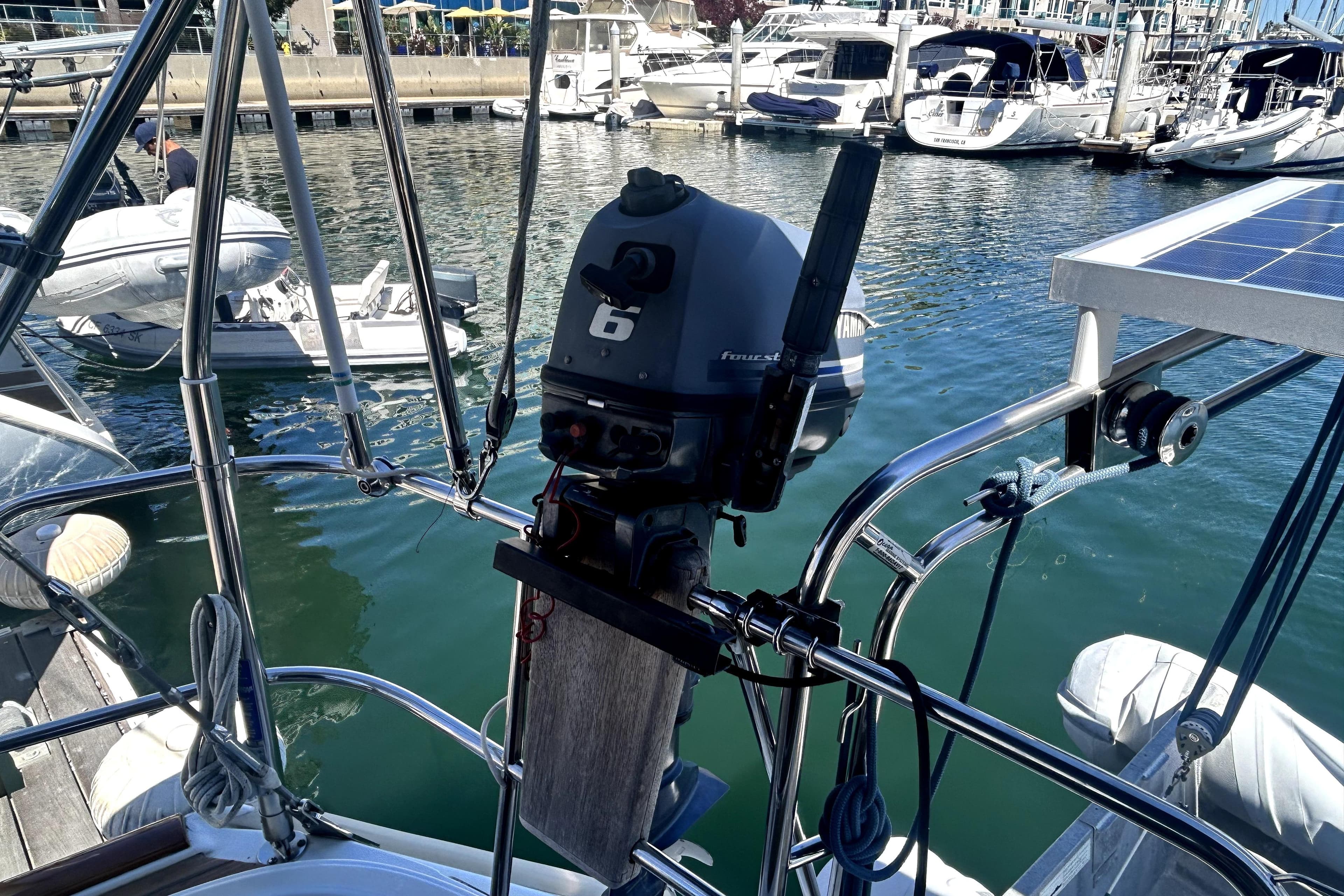 2003 Beneteau Oceanis Clipper 473 with outboard motor in marina setting.