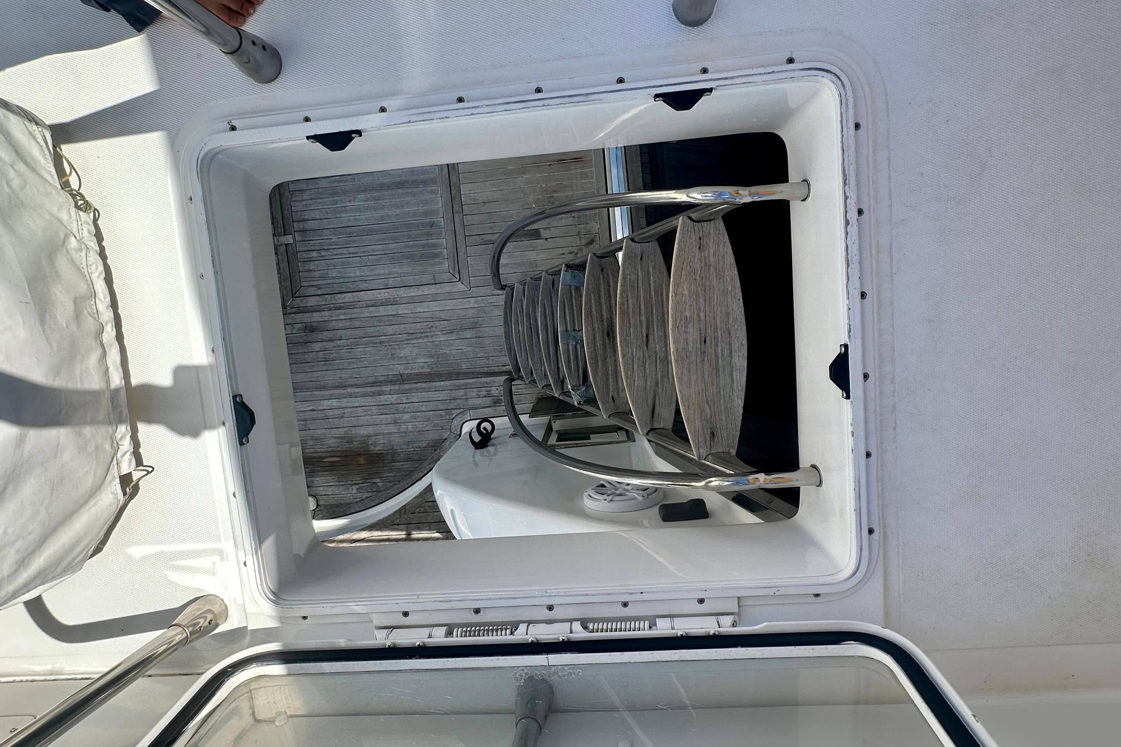 Hatch view on 1999 Azimut 58 yacht, showcasing interior ladder and deck details.