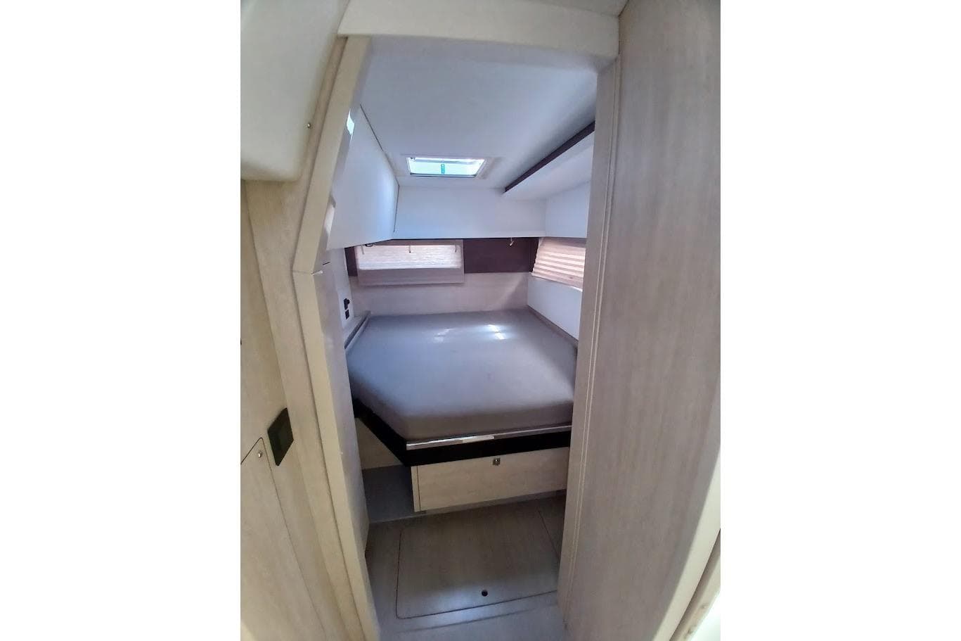 Interior cabin of 2020 Leopard 45 yacht with bed and skylight.