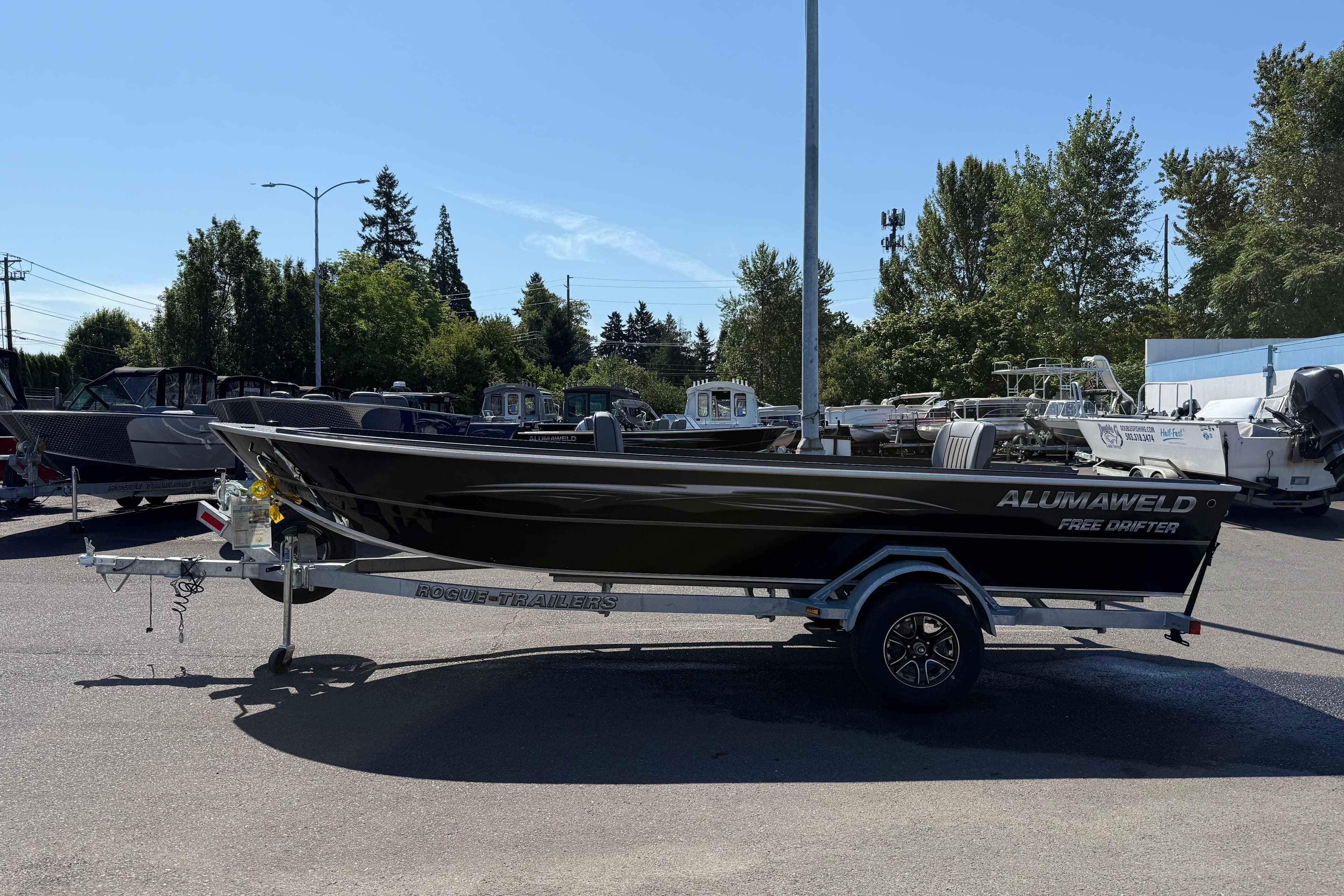 2025 Alumaweld Free Drifter 20 boat on trailer in outdoor lot.