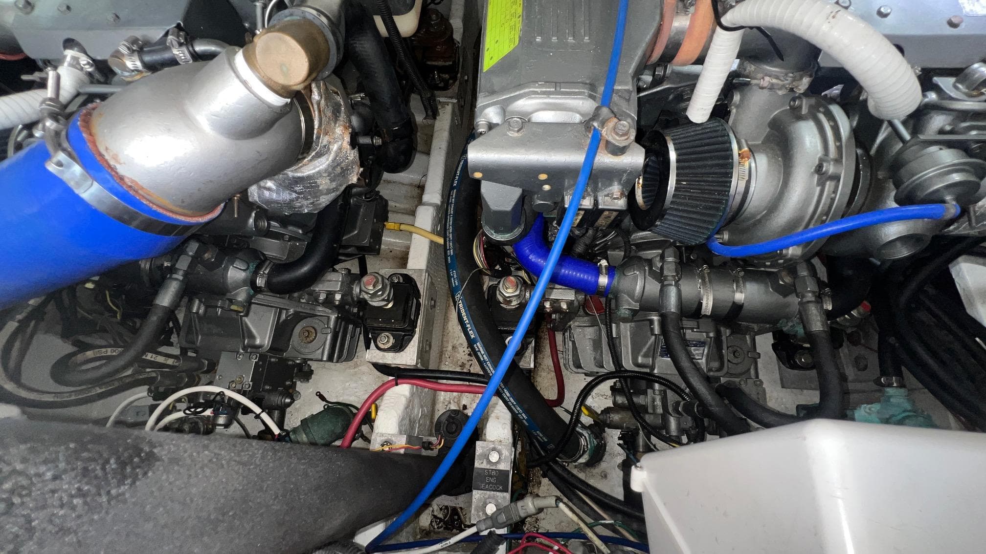 Engine compartment of a 2006 Rampage 30 Offshore boat, showcasing mechanical components and wiring.
