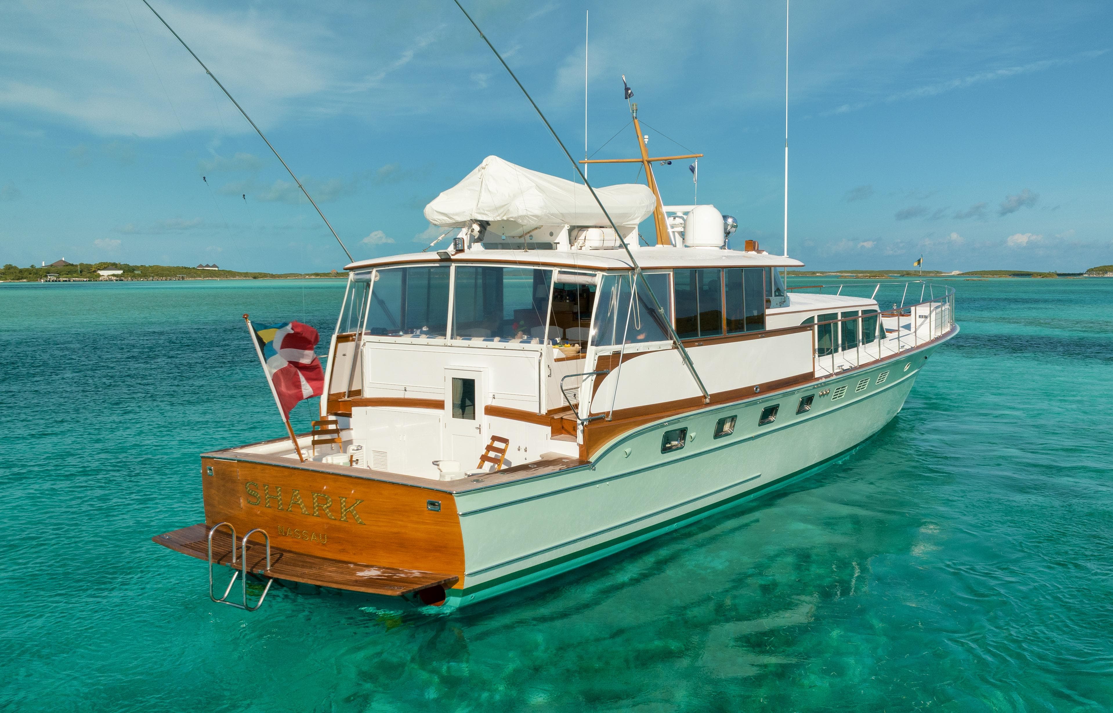 1972 Rybovich Custom yacht on clear turquoise water, featuring classic design and wooden accents.