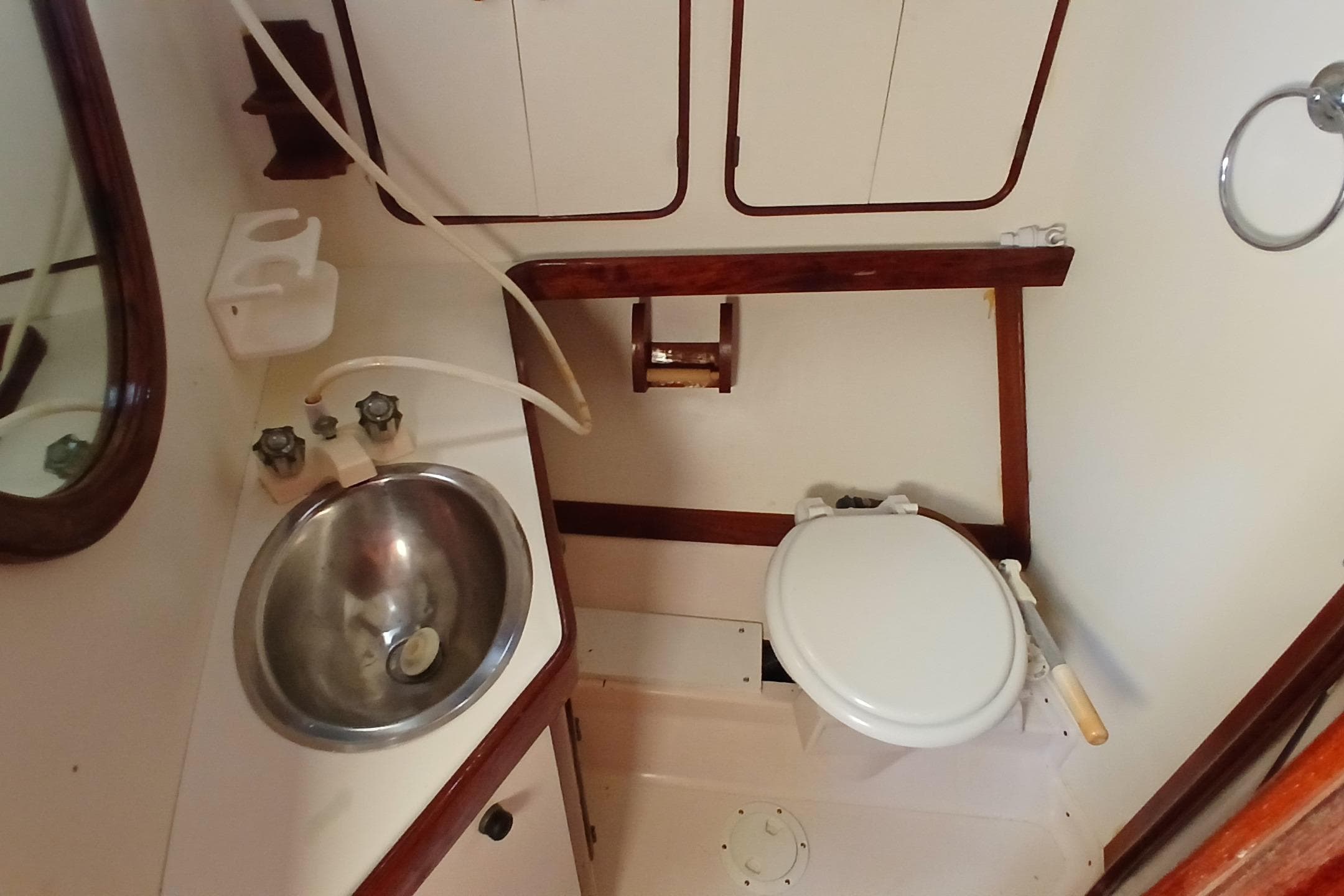 1981 Gulfstar 44 yacht bathroom with sink, toilet, and wooden accents.