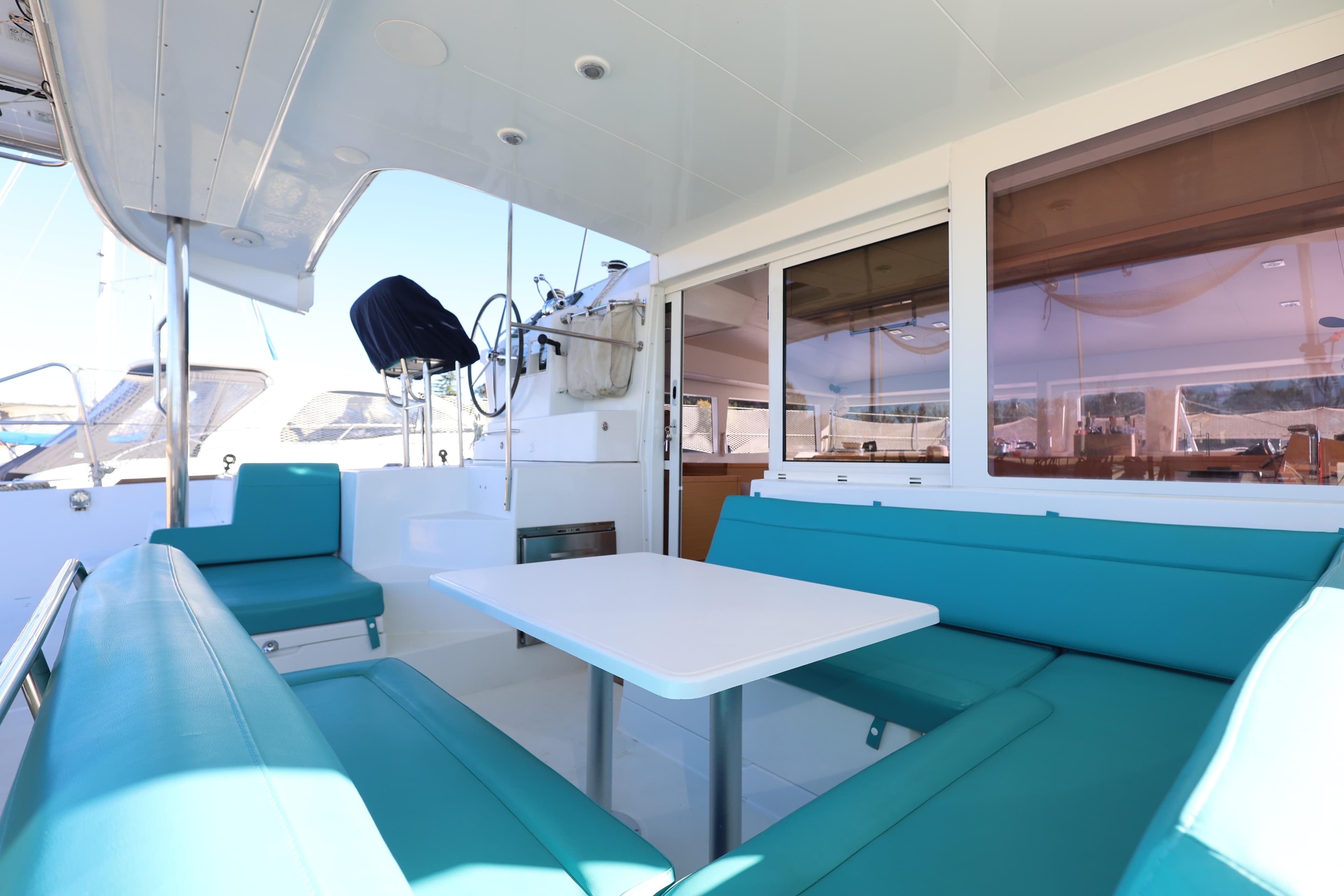 2014 Lagoon 400 S2 catamaran interior with turquoise seating and white table.