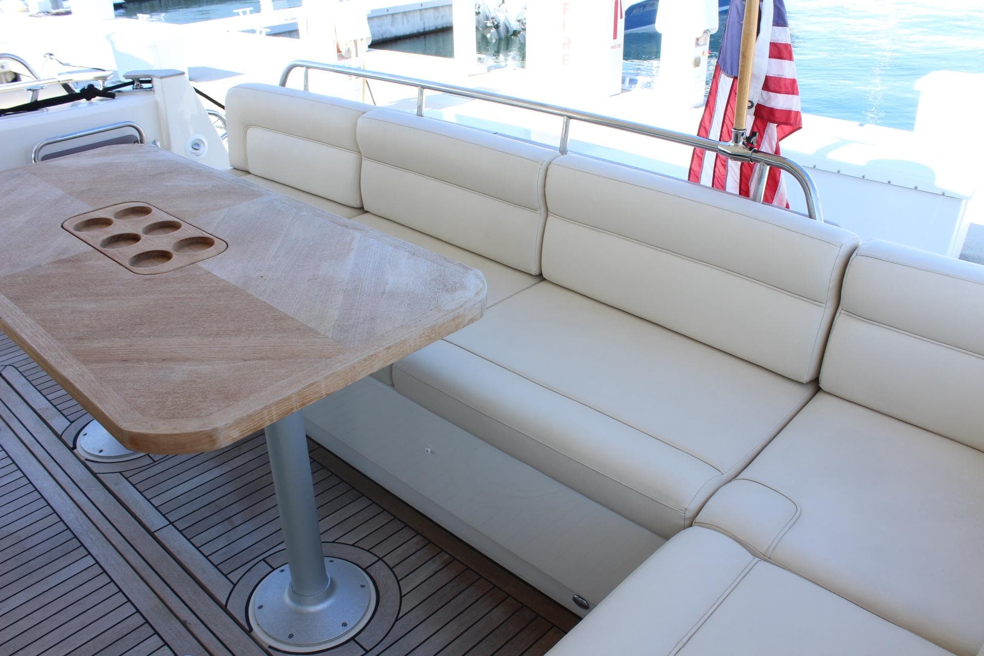 Interior of 2019 Greenline 48 Coupe with wooden table and leather sofa.