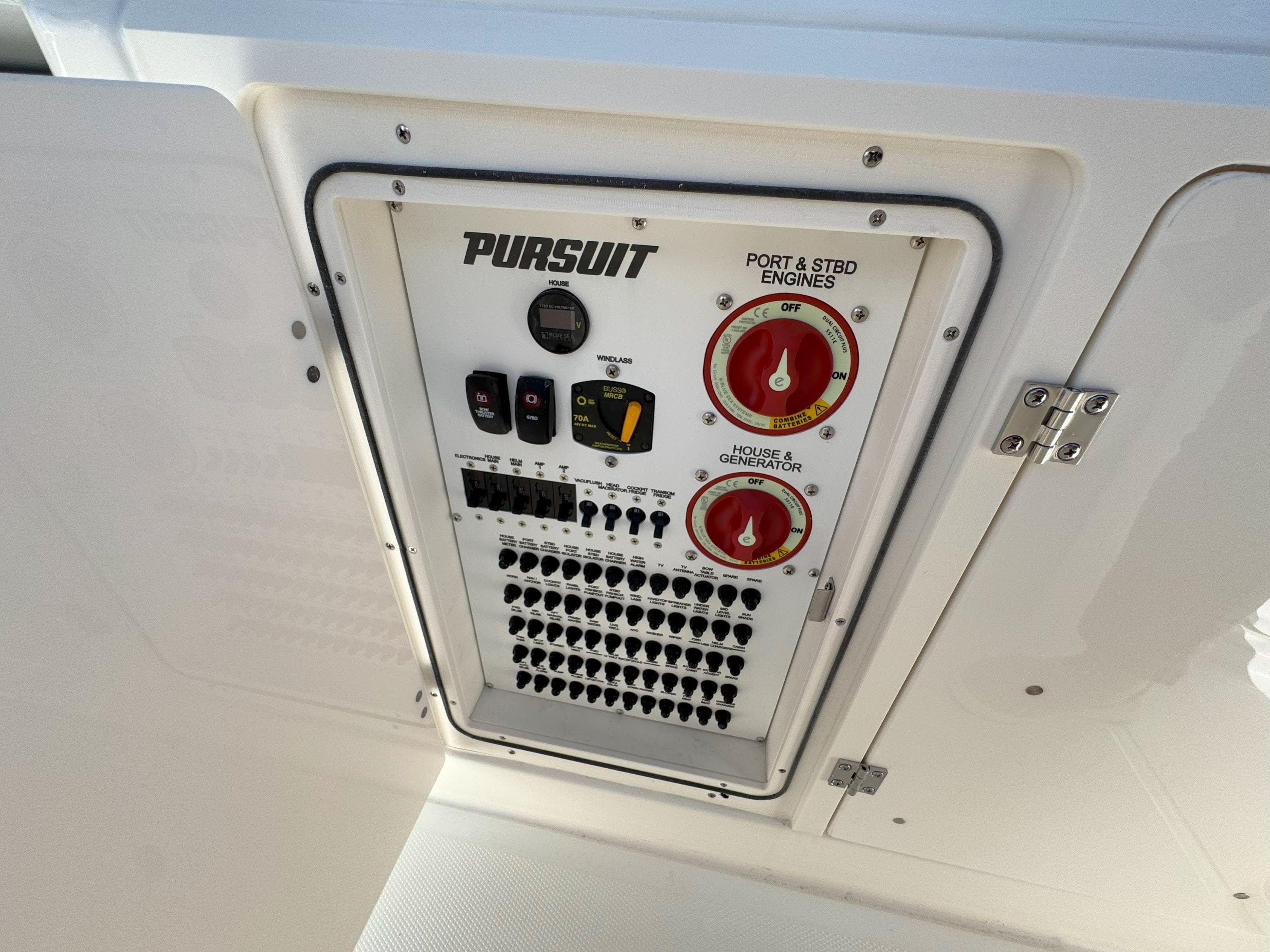 Control panel of 2025 Pursuit S 328 boat with engine and generator switches.