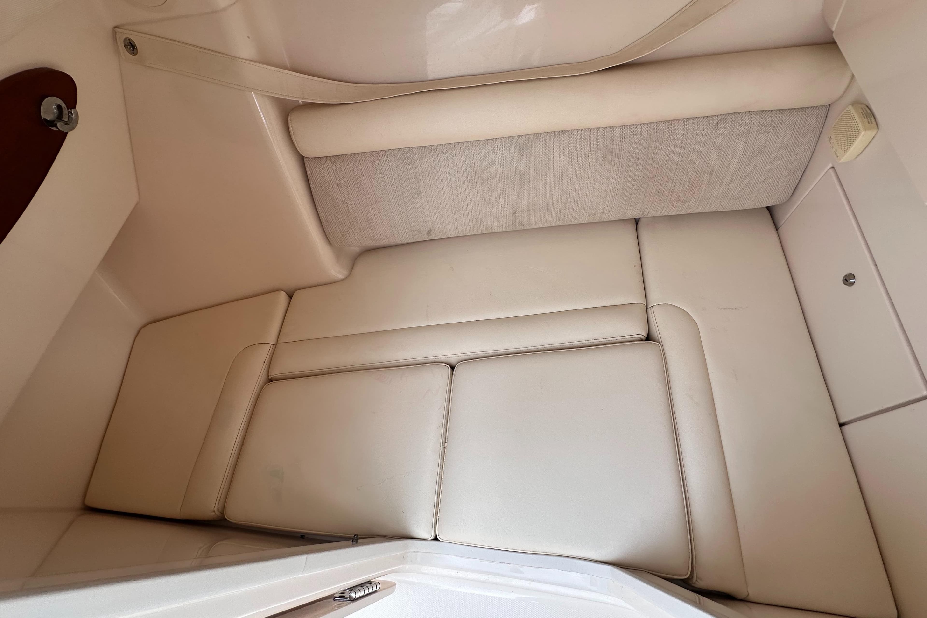2019 Grady-White Freedom 325 interior cabin with beige cushioned seating.