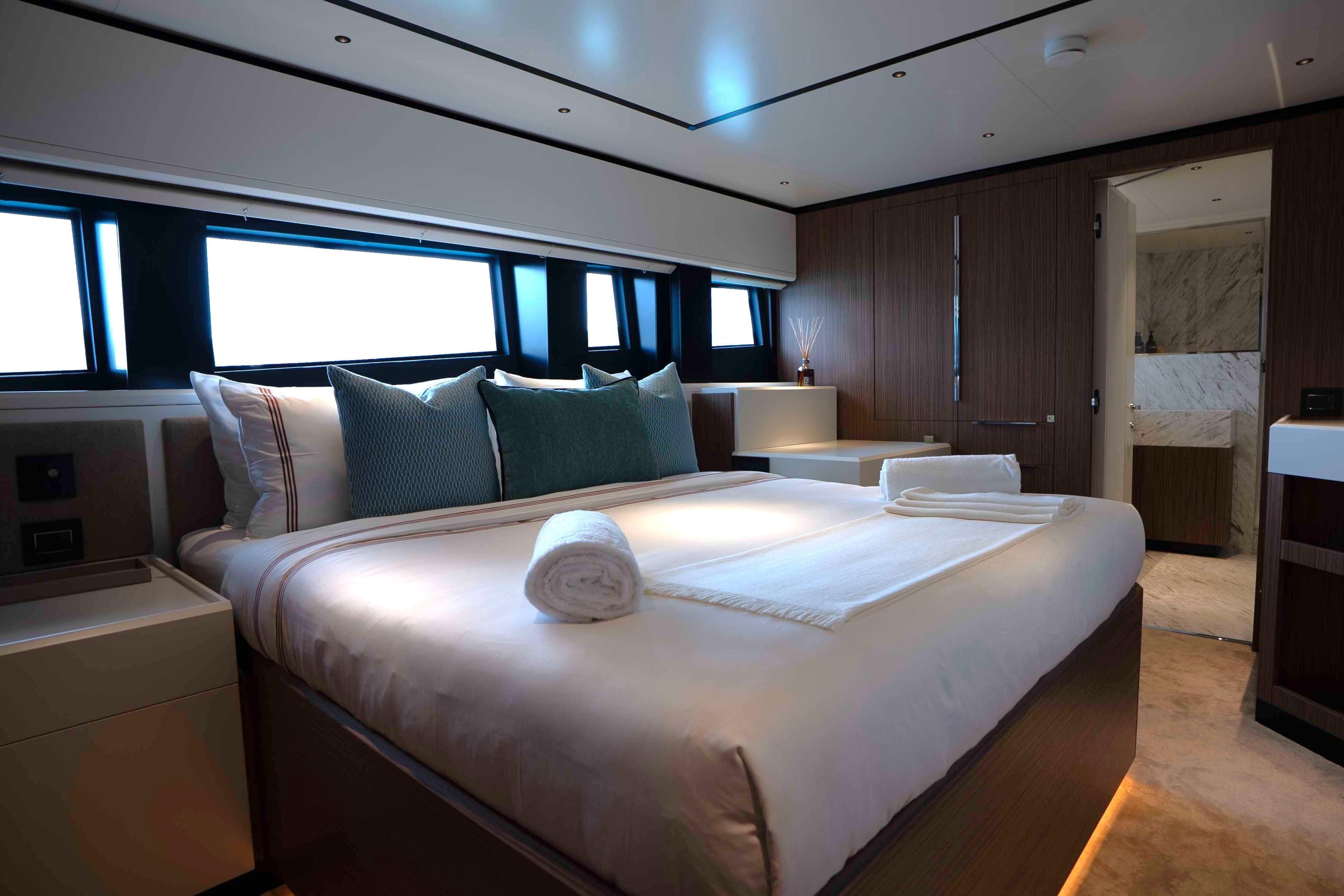 Luxurious bedroom interior of 2025 Alpha 100 Squalo Co Ownership yacht, featuring elegant design.