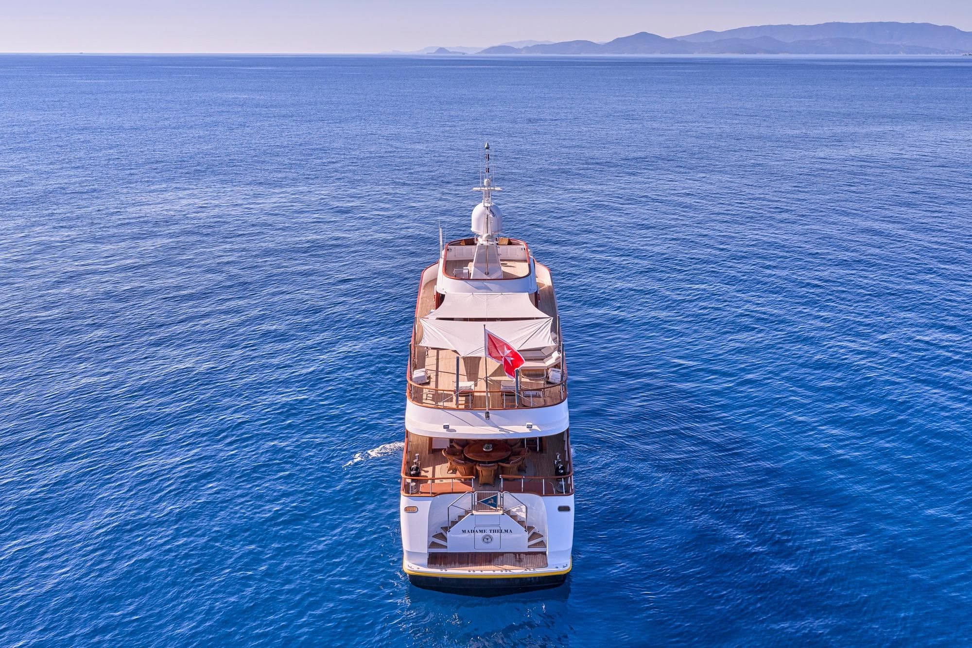 Aerial view of 1975 C CRN 40 yacht cruising on serene blue waters.