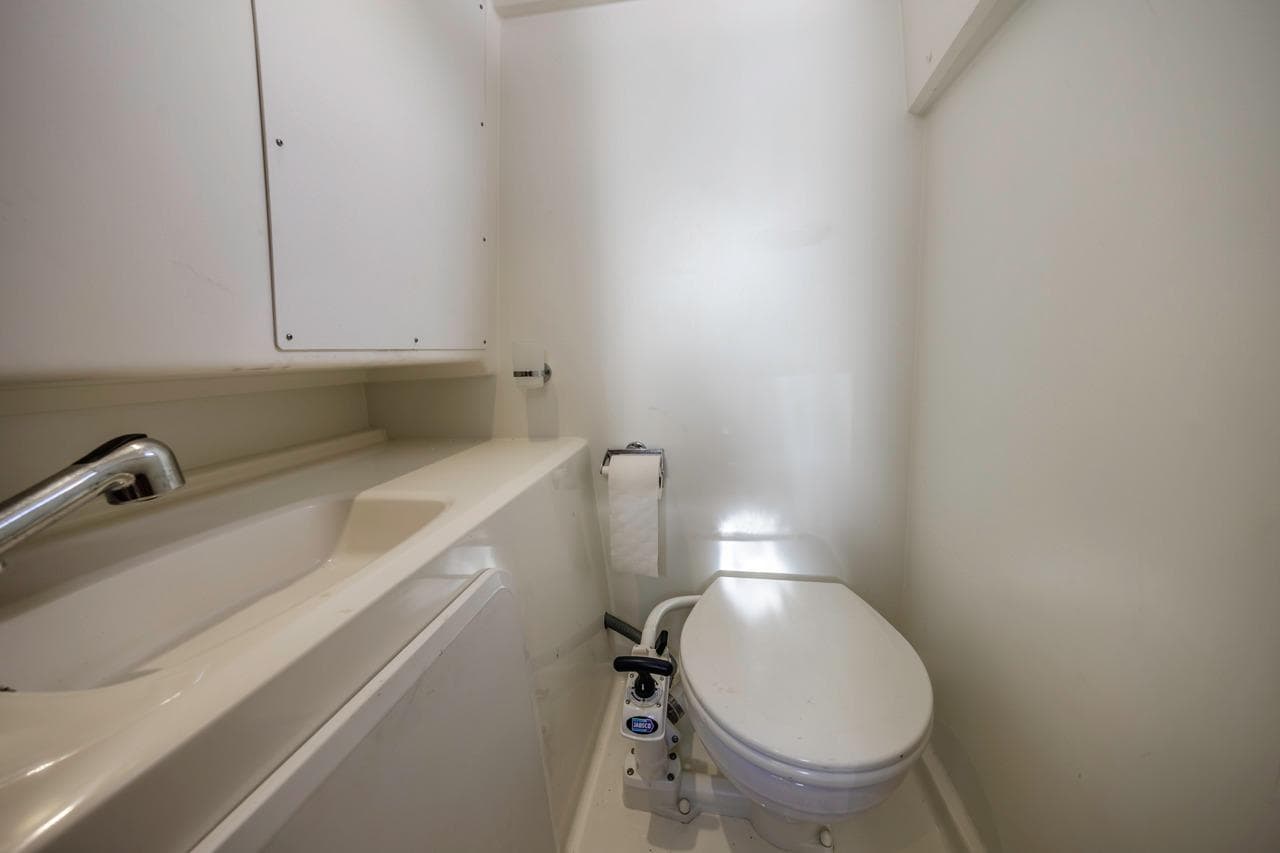 Compact bathroom in 2015 Prestige 500FB yacht with toilet and sink.