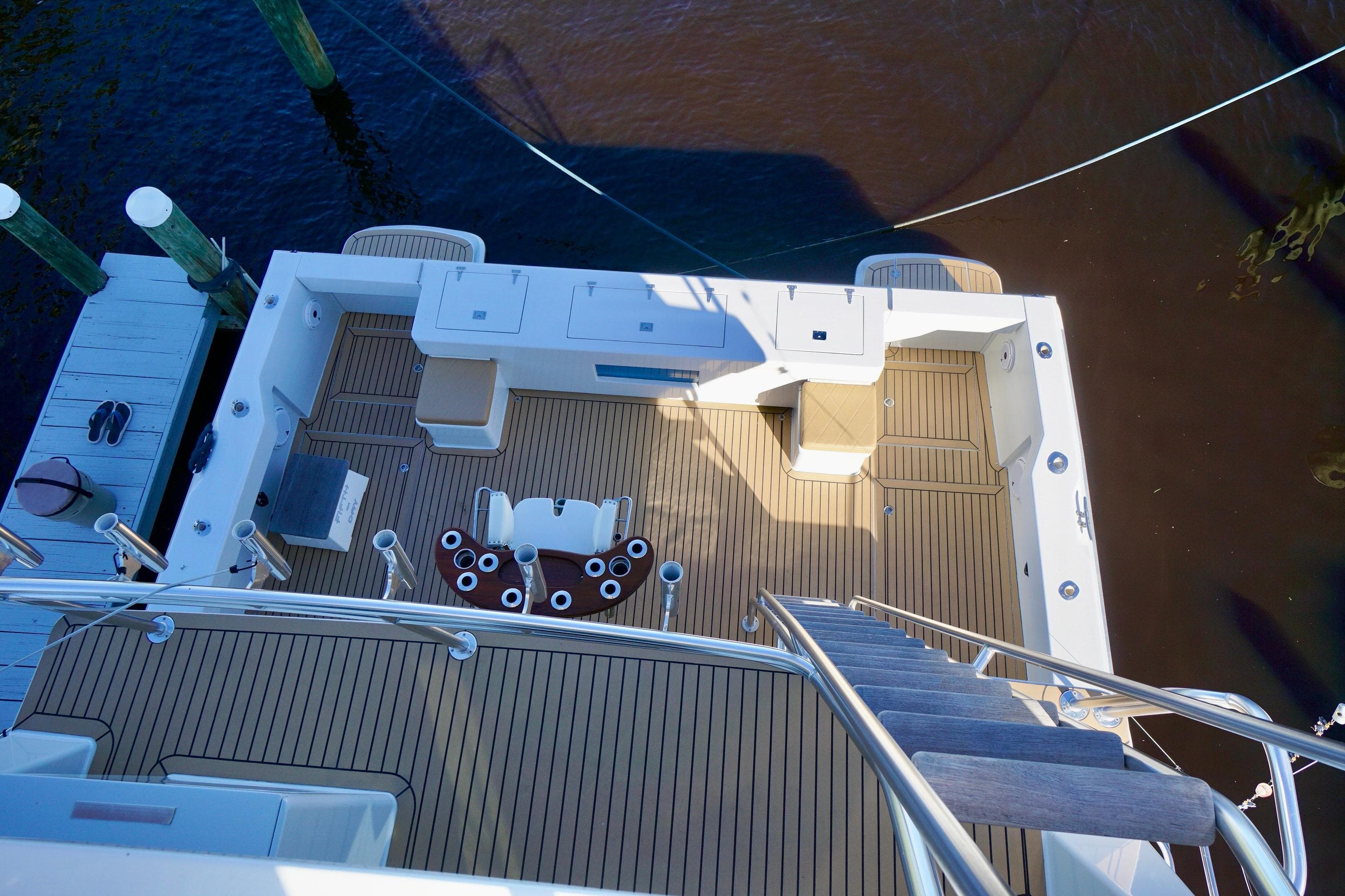 Deck view of 2000 Venturer 44 yacht with wooden flooring and seating area.