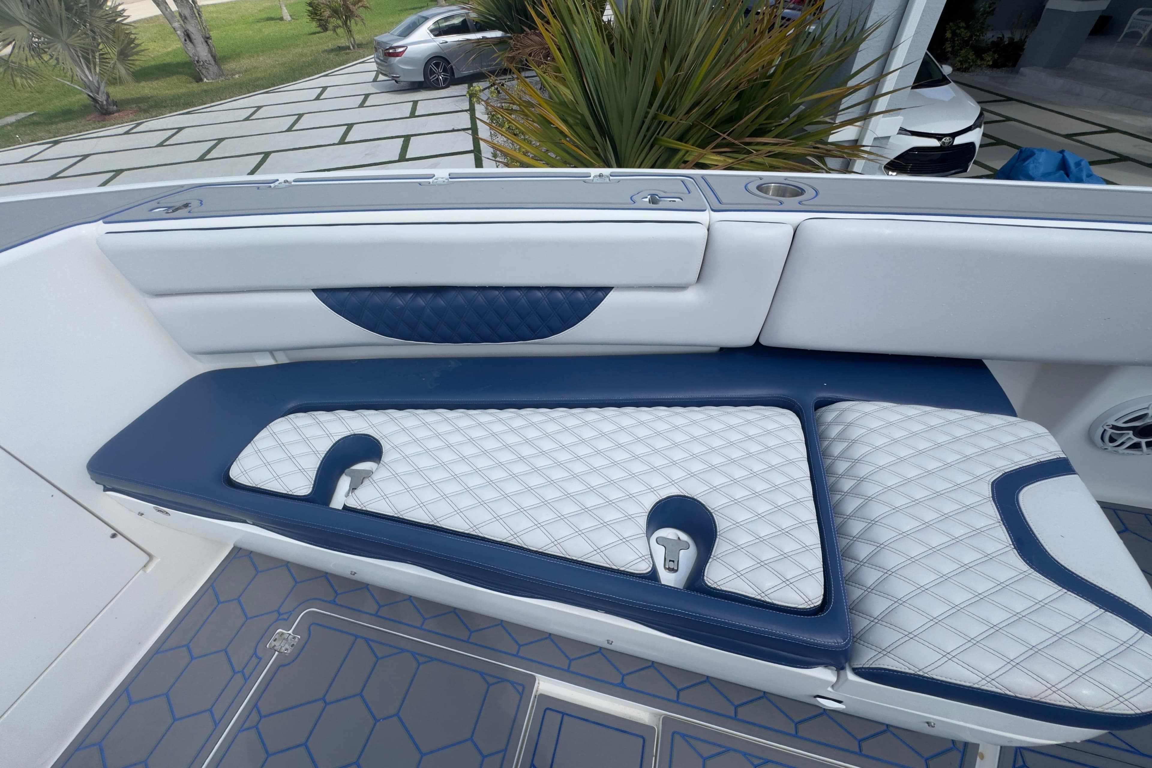 2007 Intrepid 370 Center Console boat interior with blue and white cushioned seating.