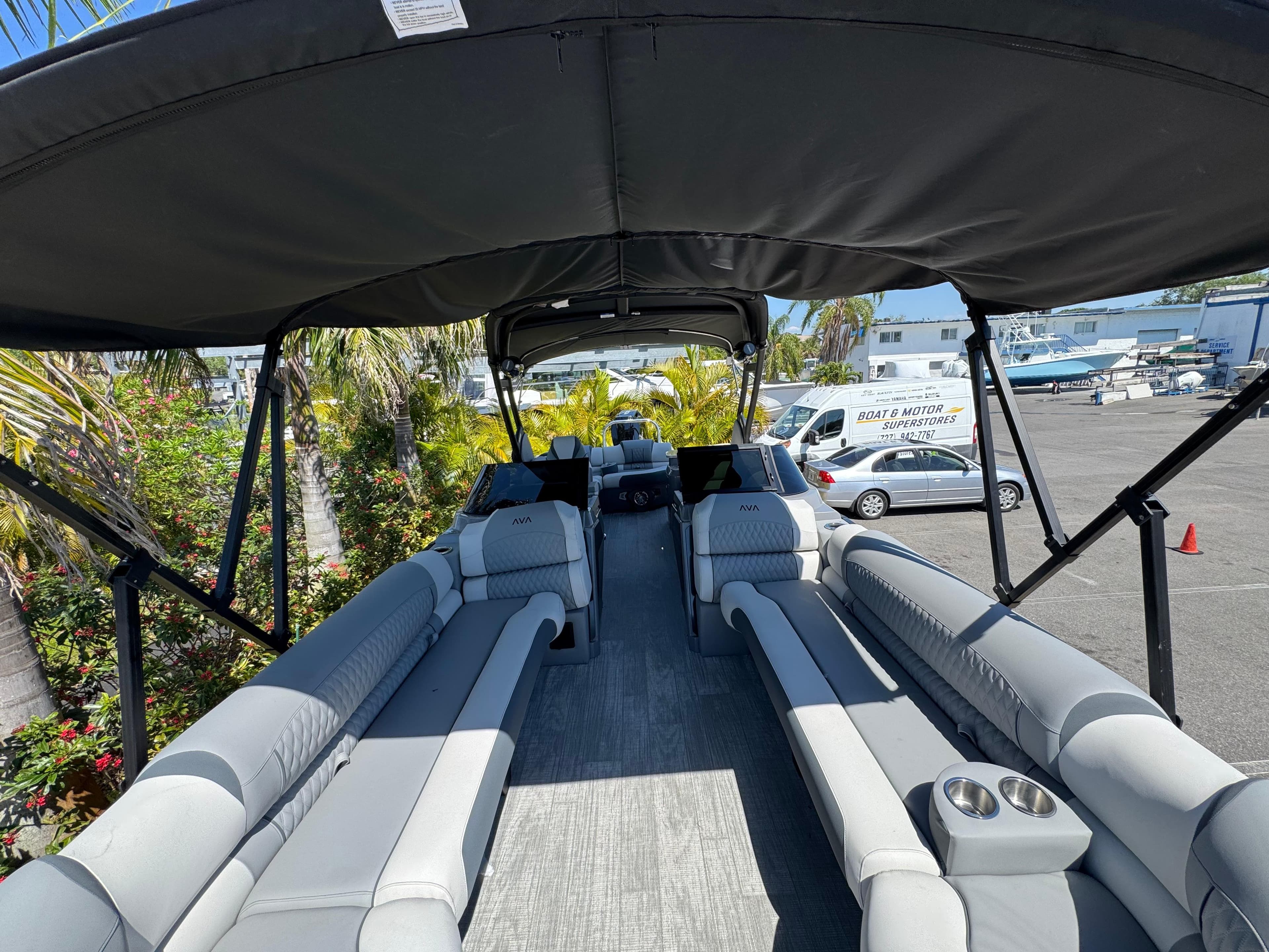 2025 Avalon Excalibur 27' pontoon boat with spacious seating and canopy in a marina setting.