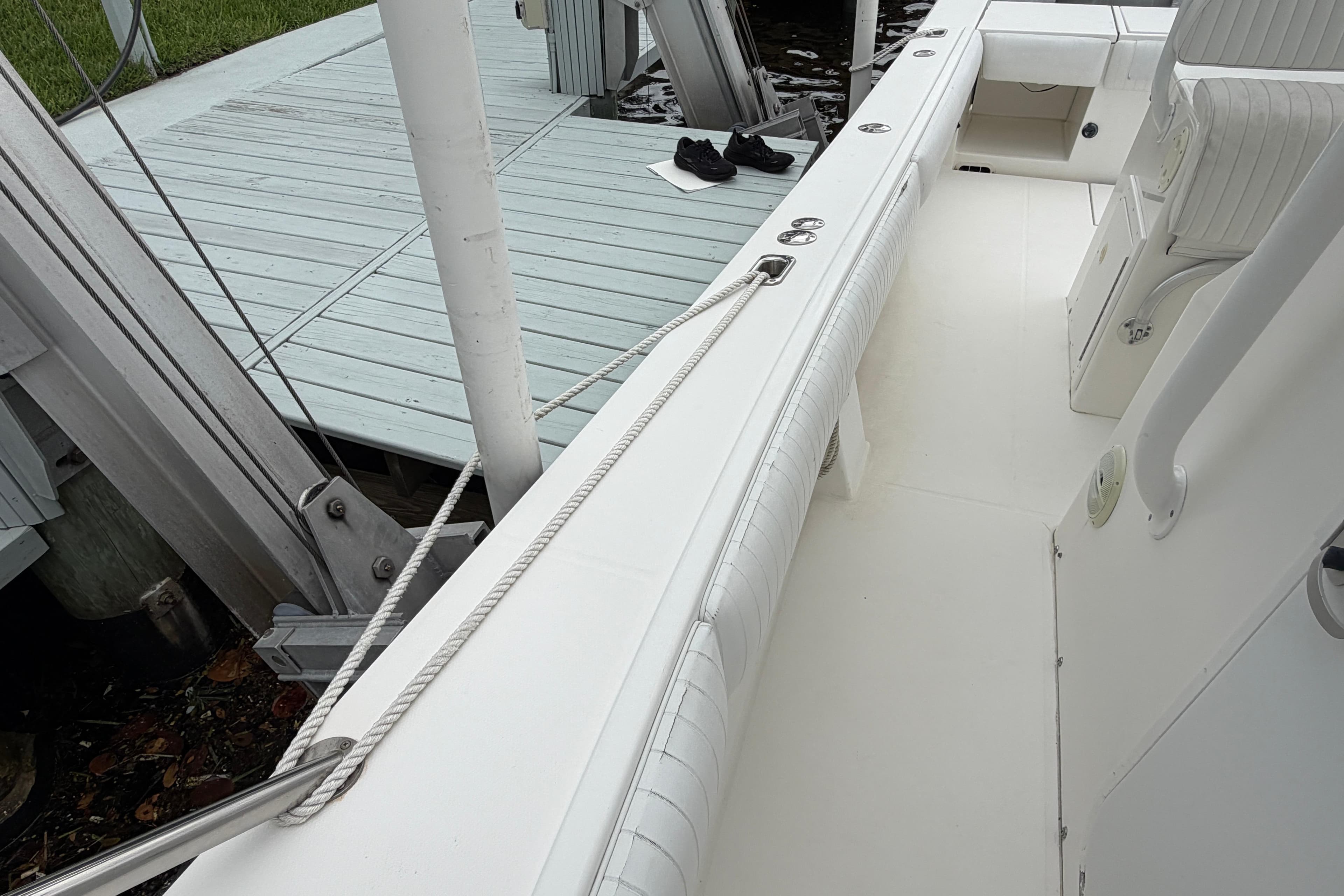 2002 Regulator 32 Forward Seating boat docked, showcasing interior seating and deck details.