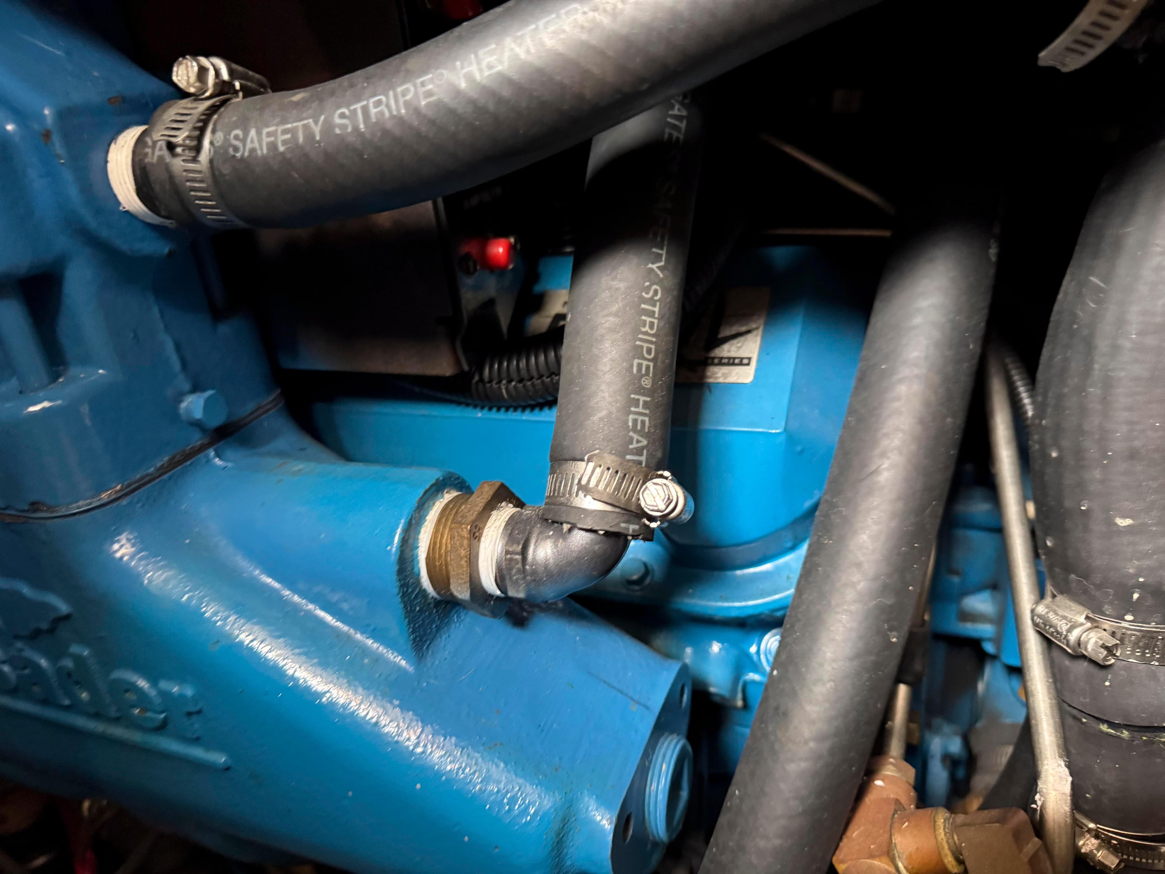 Close-up of 1997 Silverton 41 Convertible engine with blue components and hoses.