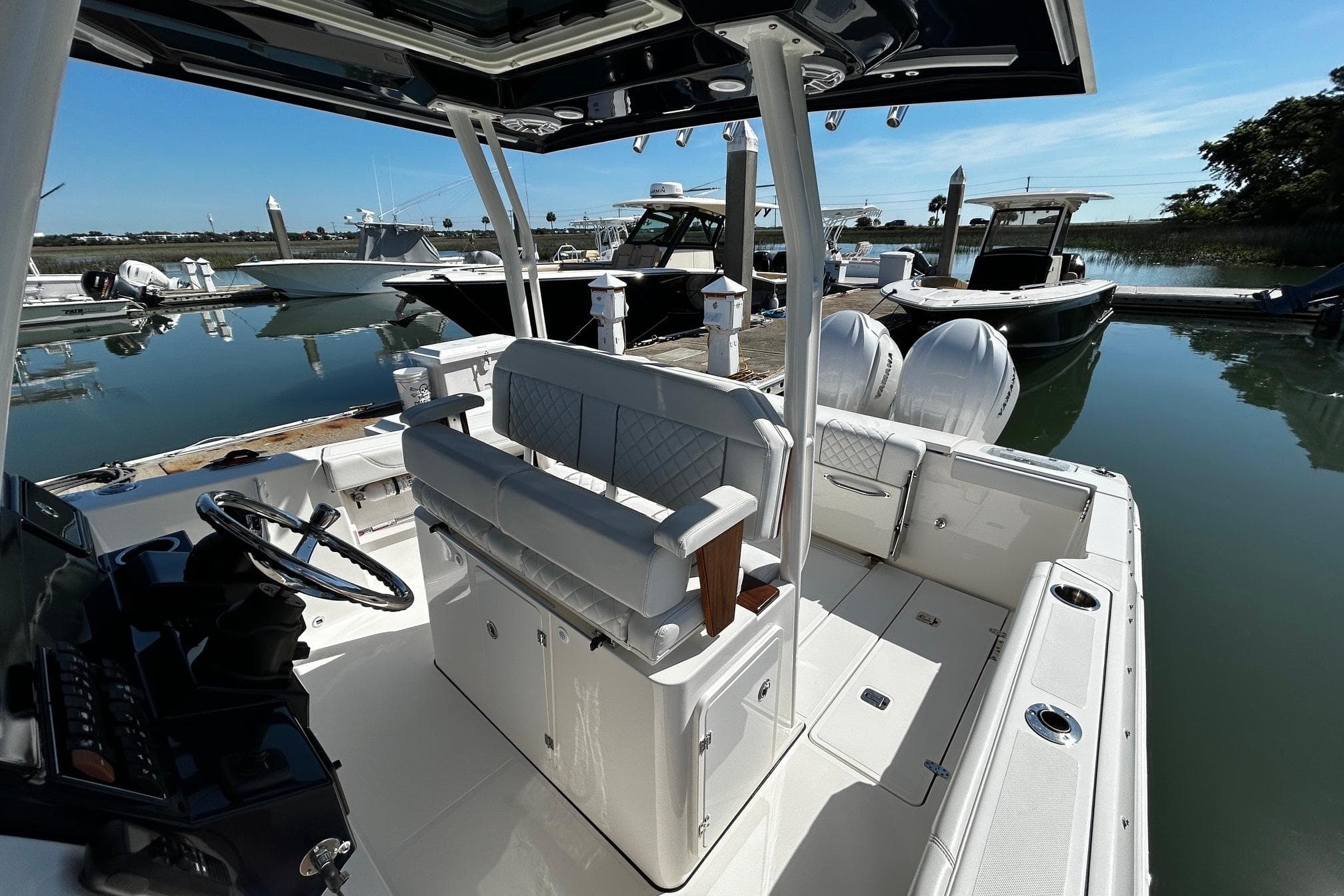 2024 Pursuit S 288 Sport boat docked at marina, showcasing sleek interior and helm.