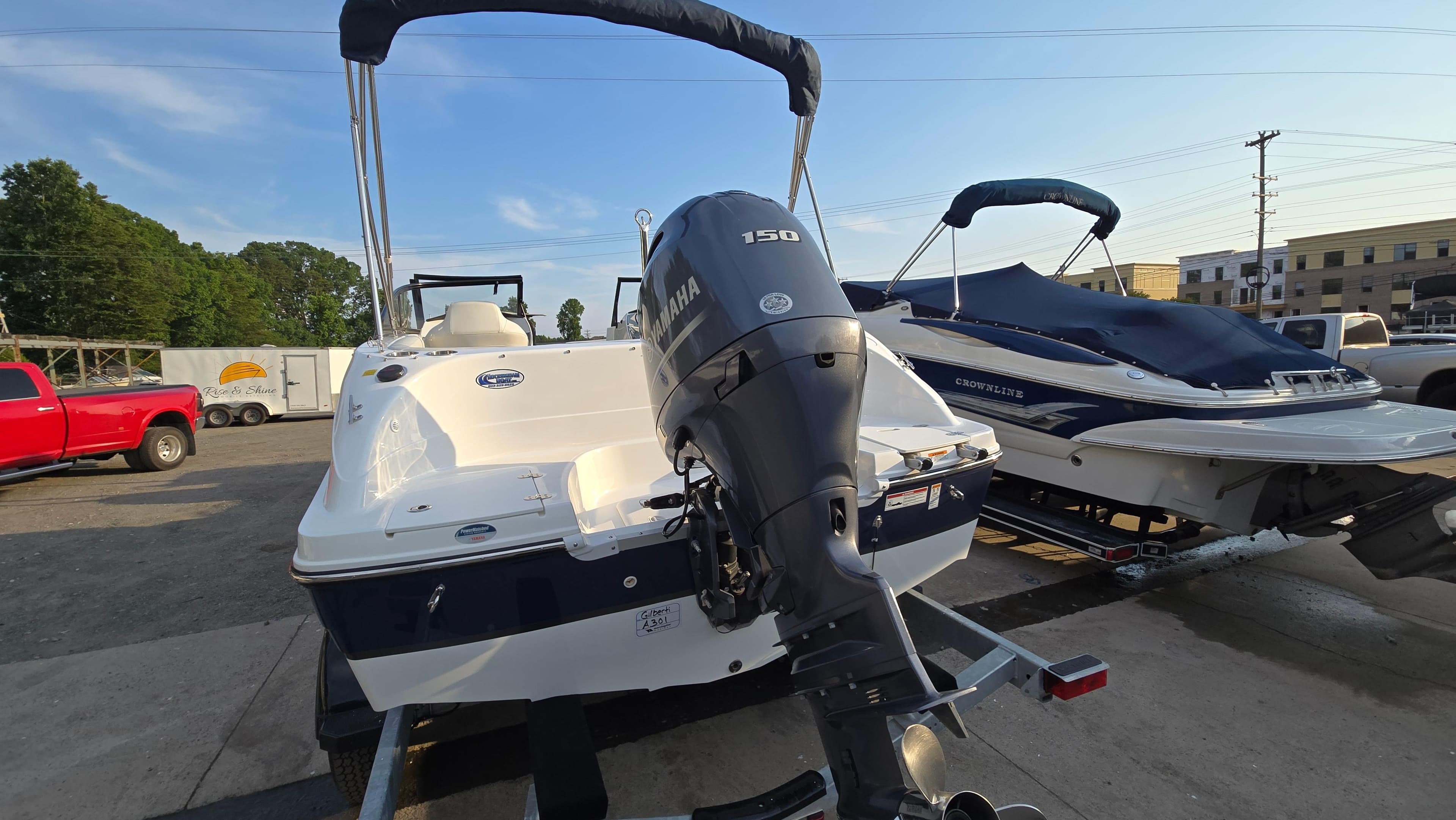 2022 Hurricane SunDeck 191 OB boat with Yamaha 150 engine, parked outdoors.