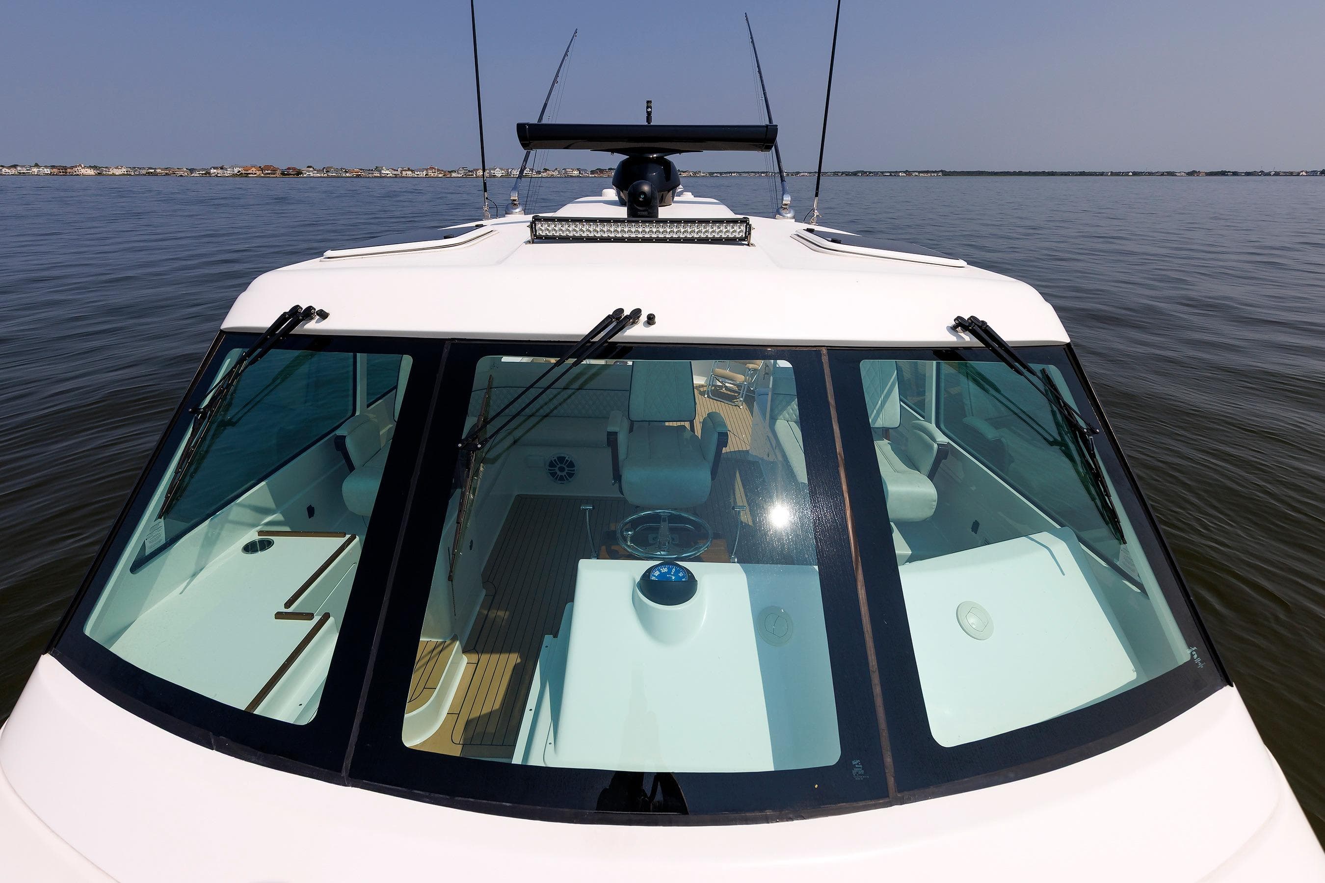 2023 Henriques 42 Express Hardtop boat on calm water, showcasing sleek design and spacious interior.