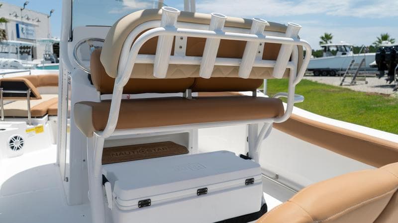 2024 NauticStar 222 OSL boat interior with tan seating and rod holders.