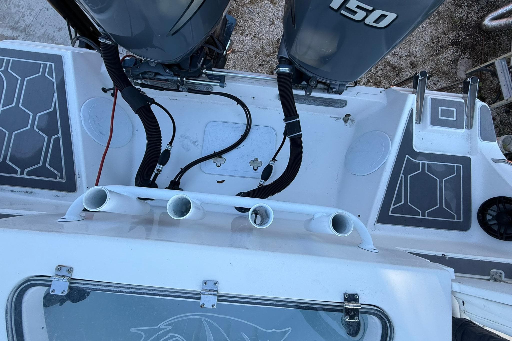 2014 Sea Fox 256 Commander boat deck with dual 150 engines and rod holders.