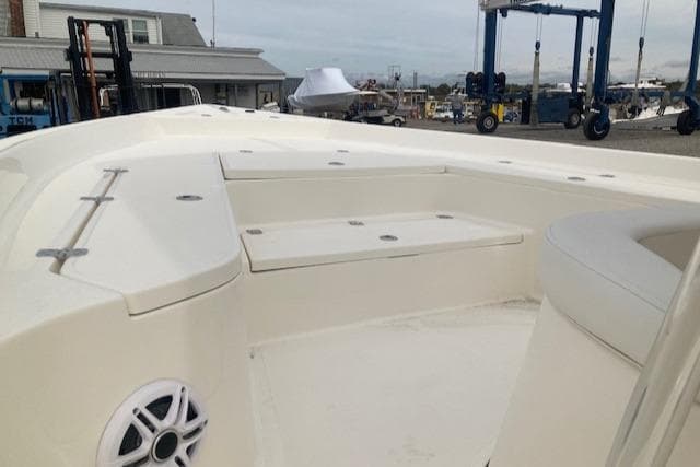 2023 Bulls Bay 2400 boat interior with seating and speaker, dockside view.