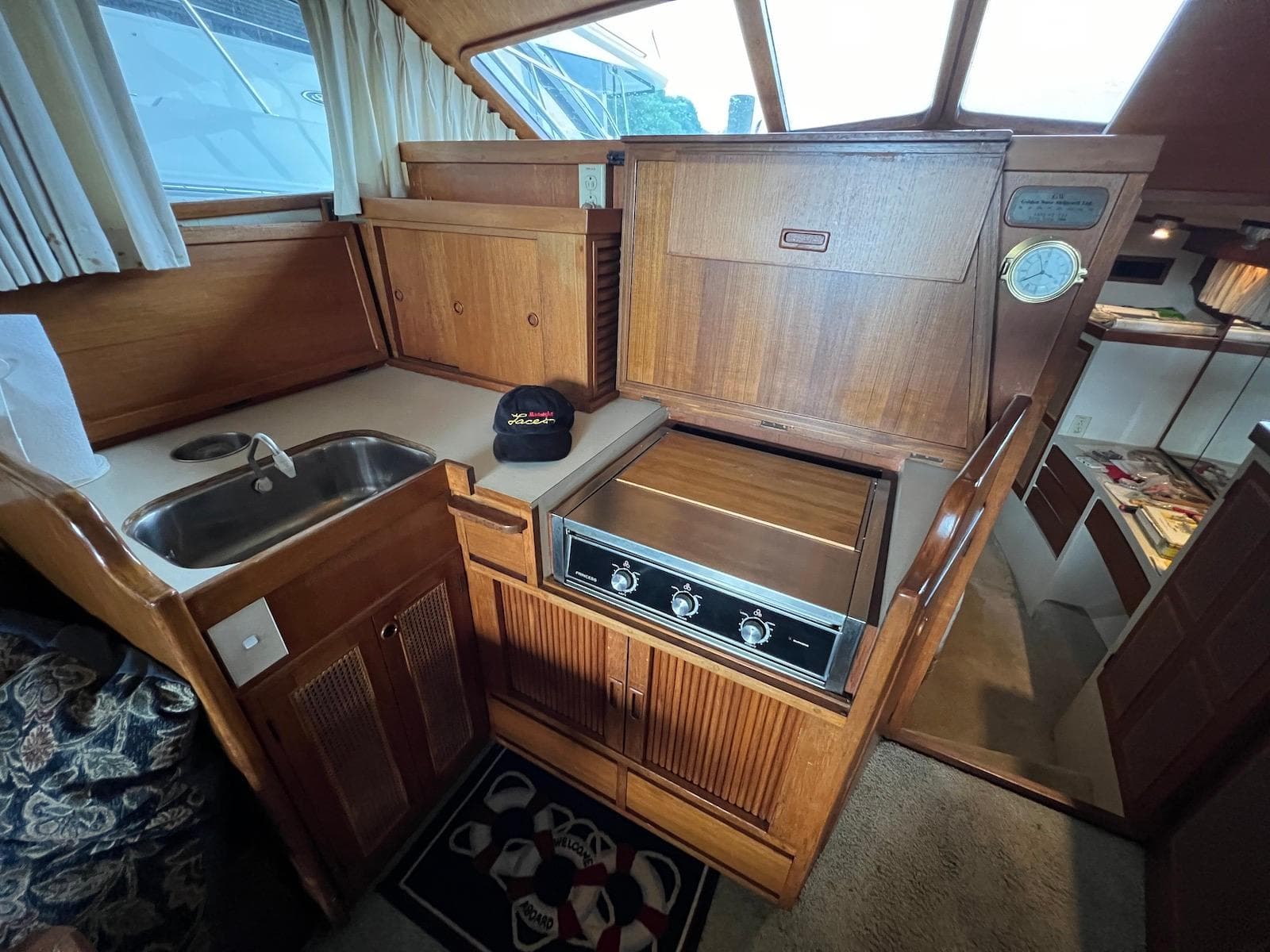 1986 Midnight Lace 44 Flybridge Express Cruiser kitchen with wood cabinetry and compact appliances.