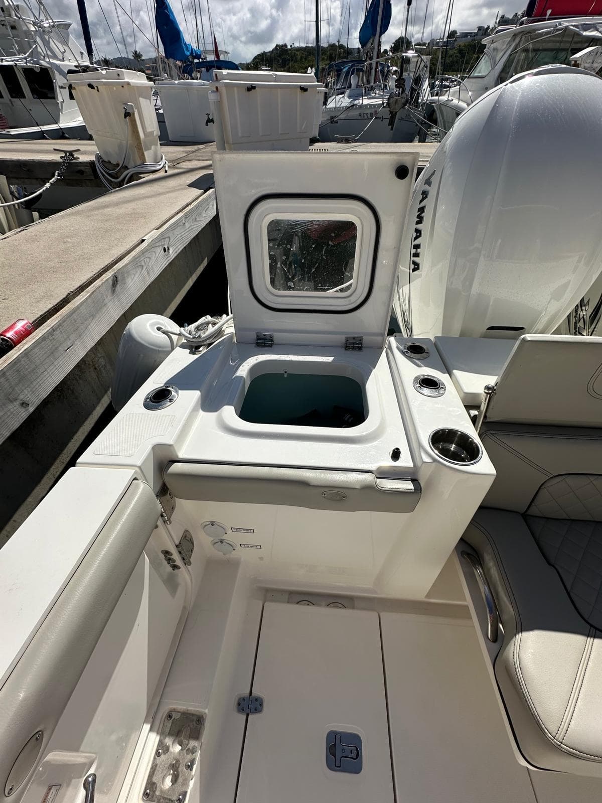 2023 Pursuit S 358 Sport boat interior with open storage compartment.