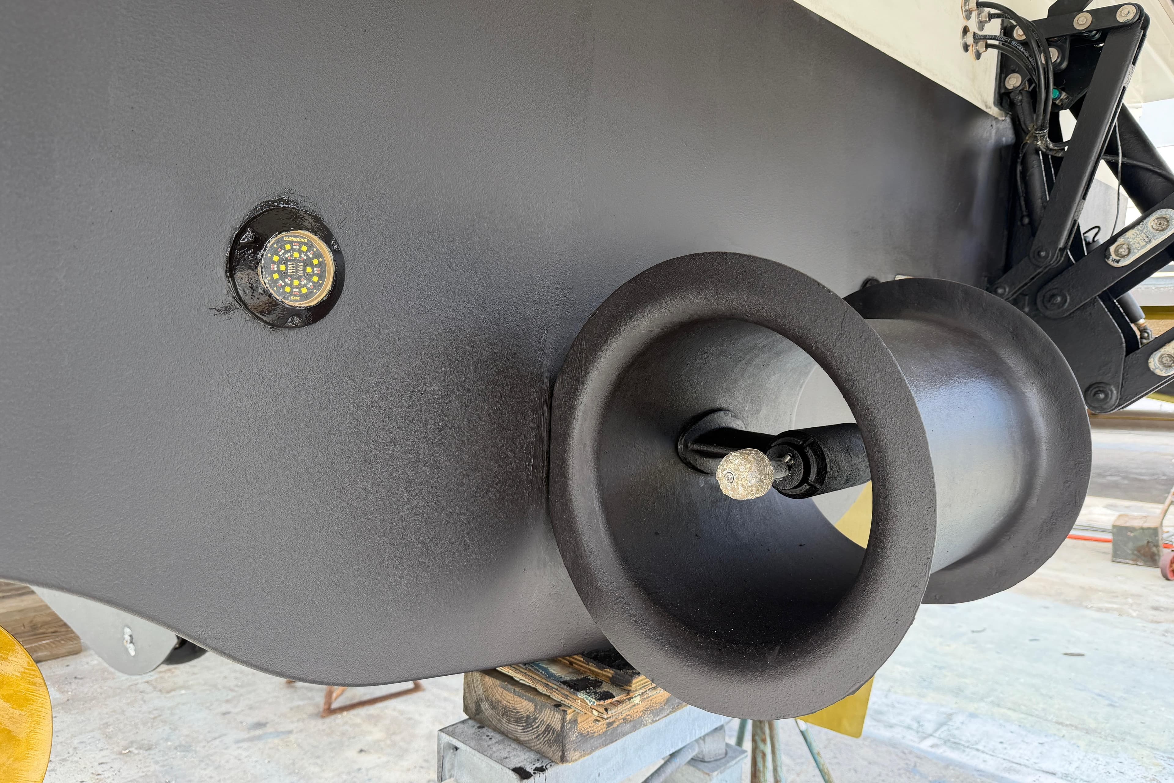 Close-up of 2022 Beneteau Grand Trawler 62 hull and thruster detail.