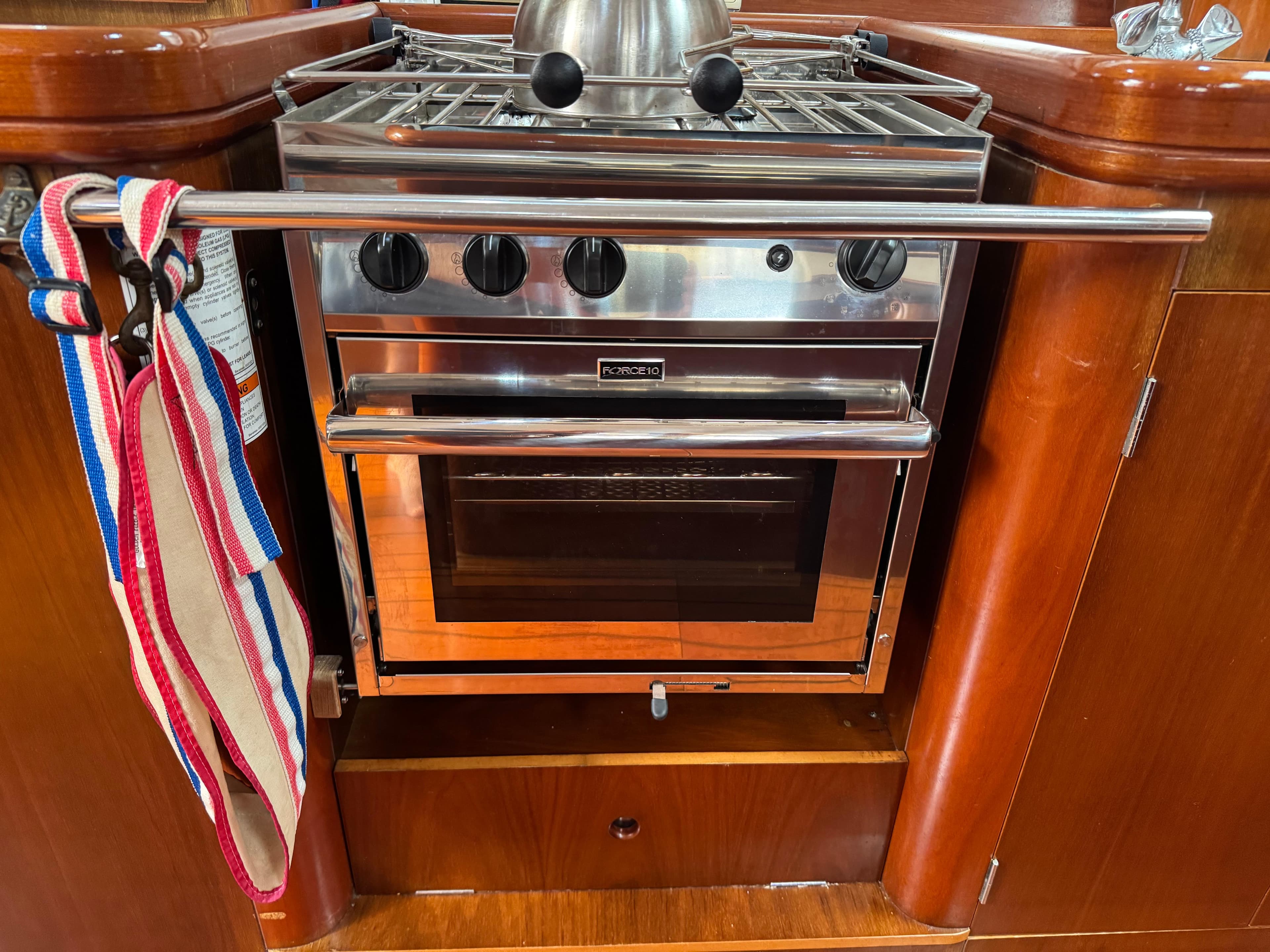Stainless steel stove and oven in 1997 Beneteau Oceanis 461 yacht kitchen.