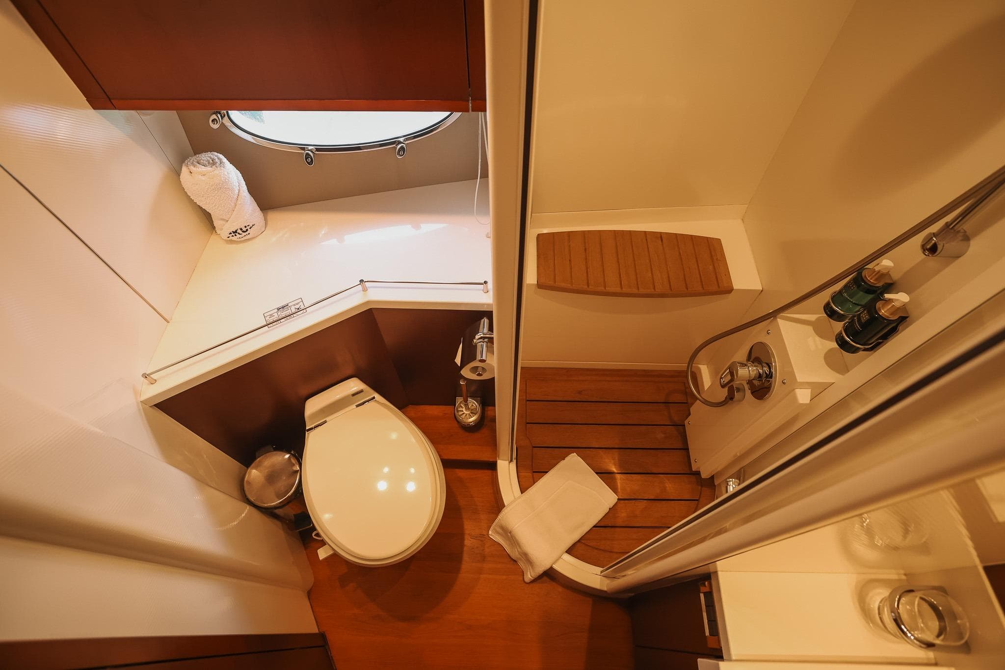 Luxurious bathroom on 2008 Princess V65 yacht with modern fixtures and wooden accents.