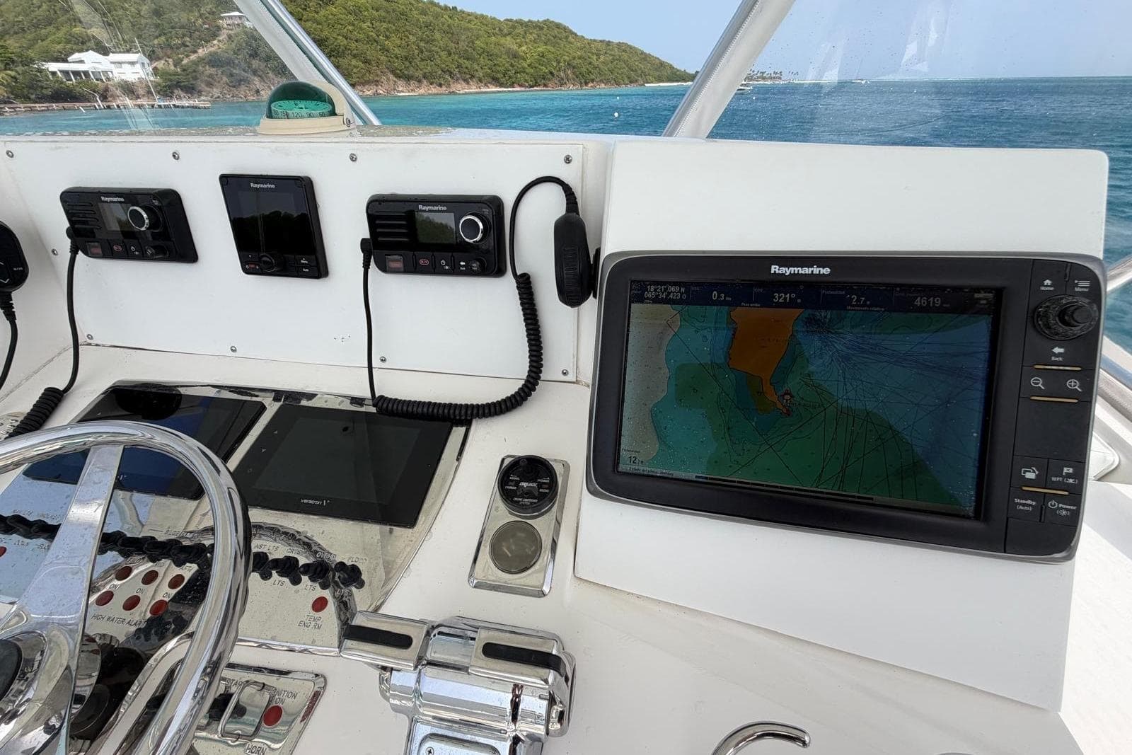 Helm of 2004 Cabo 35 Flybridge with navigation equipment and ocean view.