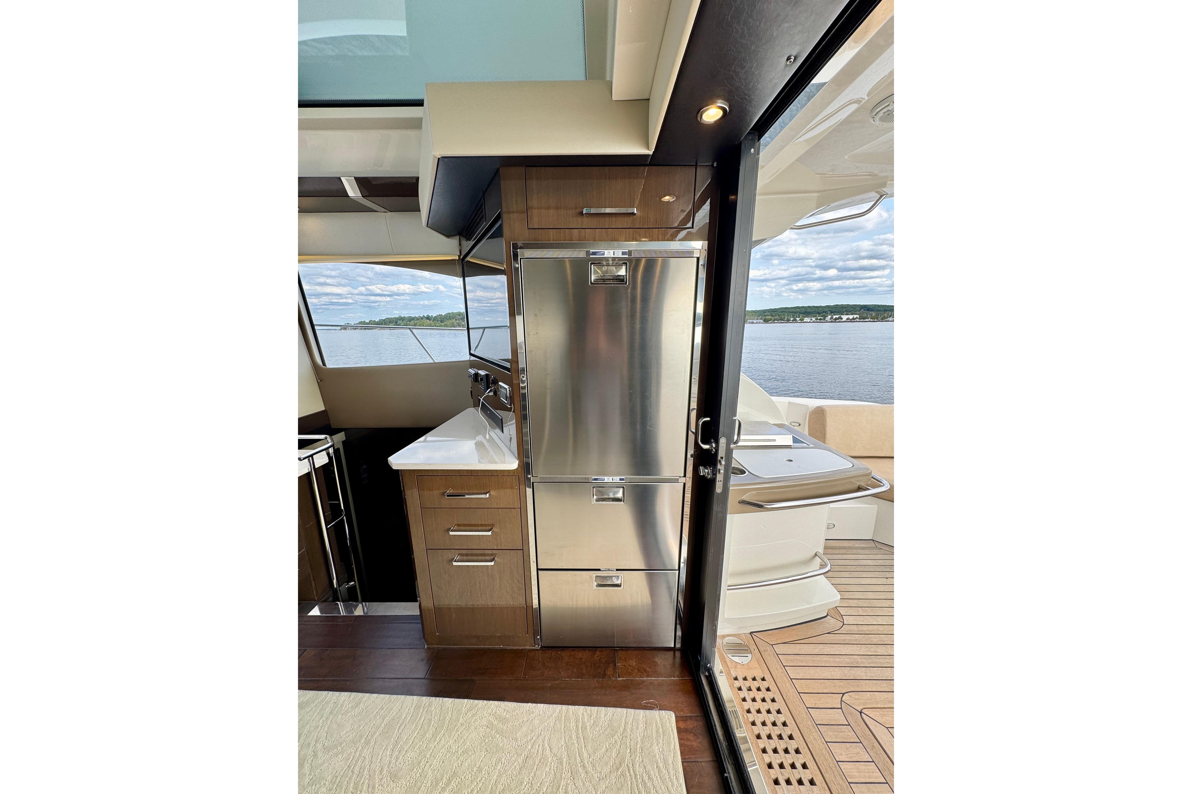 Interior of 2018 Carver C52 Coupe yacht with modern kitchen and scenic water view.