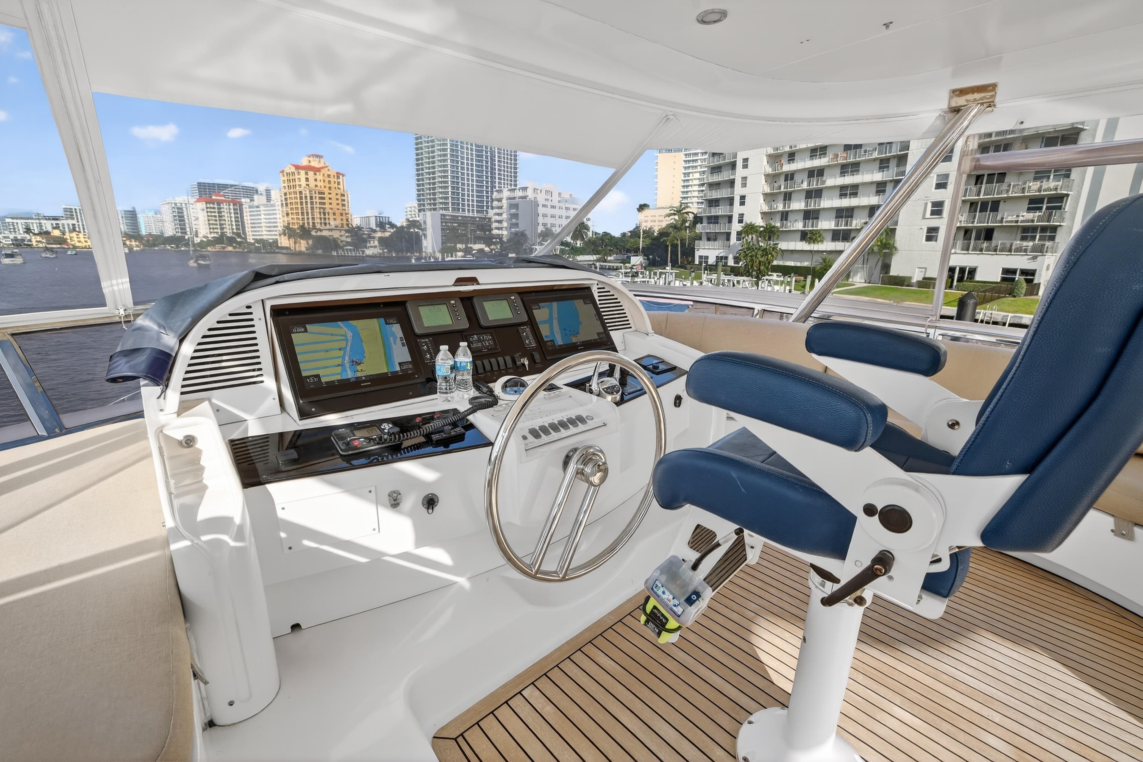 2009 Horizon Flybridge yacht helm with blue captain's chair and navigation screens.