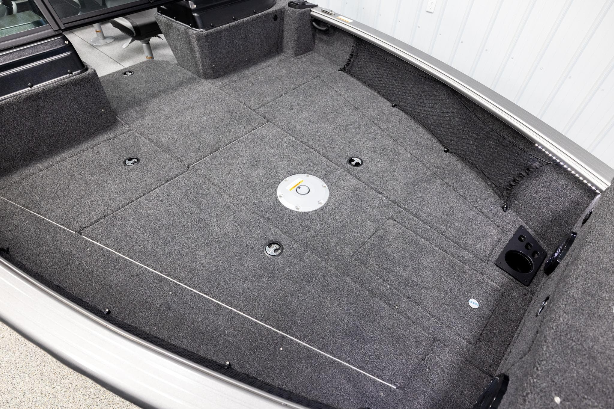 2026 Lund 2075 Impact XS boat interior with spacious carpeted deck and storage compartments.