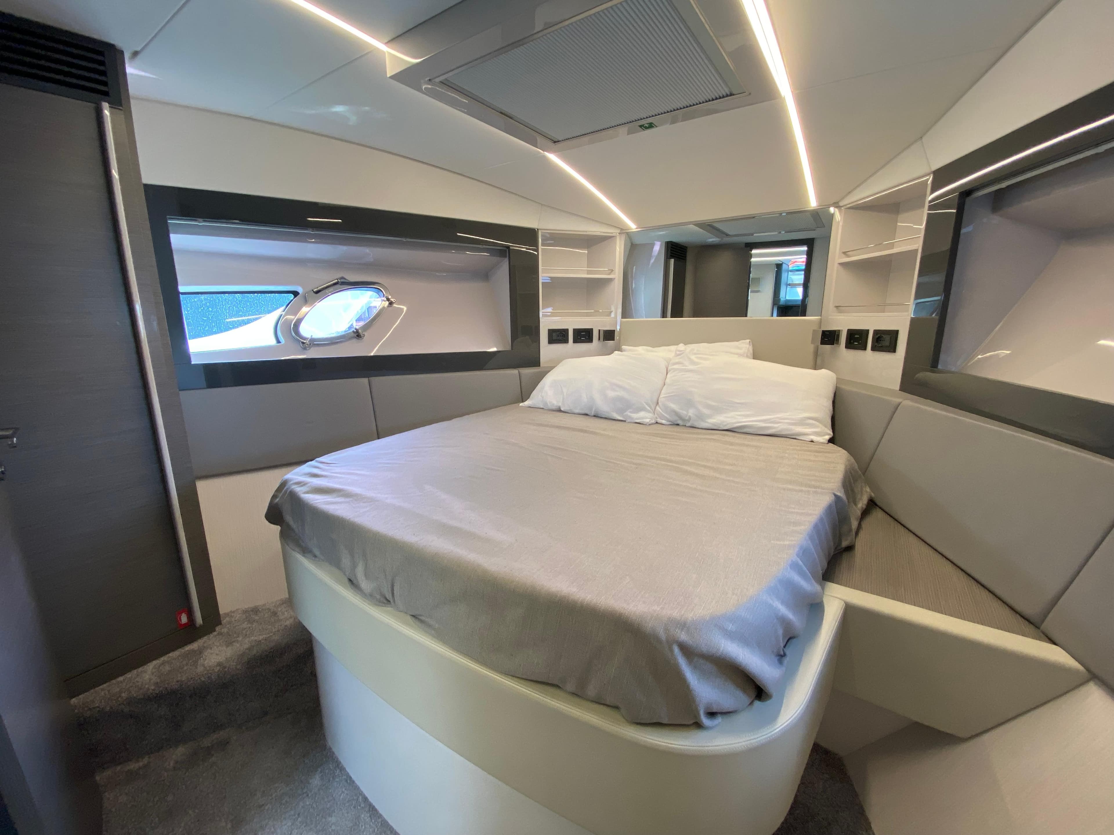 Luxurious bedroom interior of 2018 Pershing 5x yacht with modern design and ambient lighting.