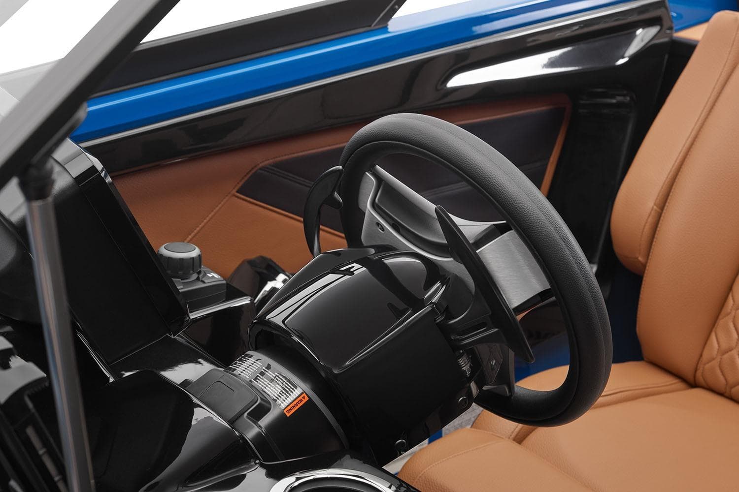 Manufacturer Provided Image: 2026 Yamaha Boats 255XD interior, featuring sleek steering wheel and luxurious tan seating.