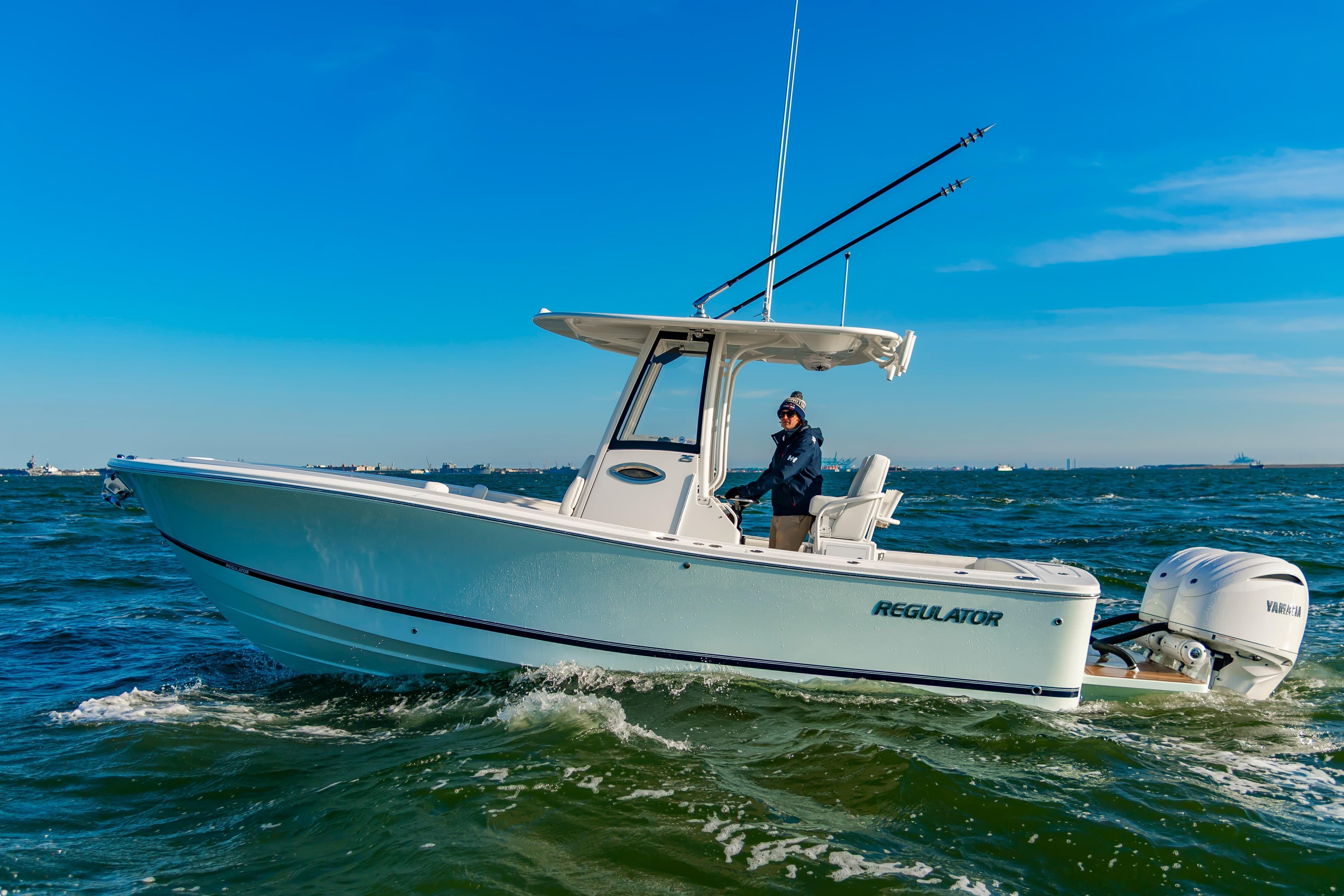 2026 Regulator 25 boat cruising on open water under clear blue skies.