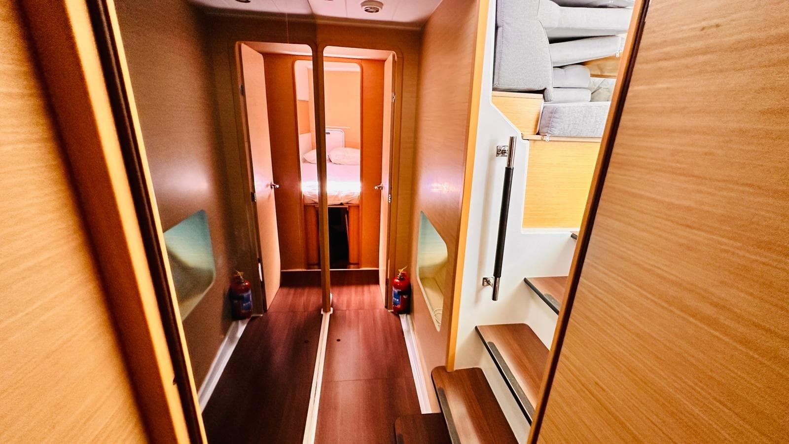 Interior of 2011 Lagoon 400 catamaran, featuring wooden finishes and cozy cabin layout.