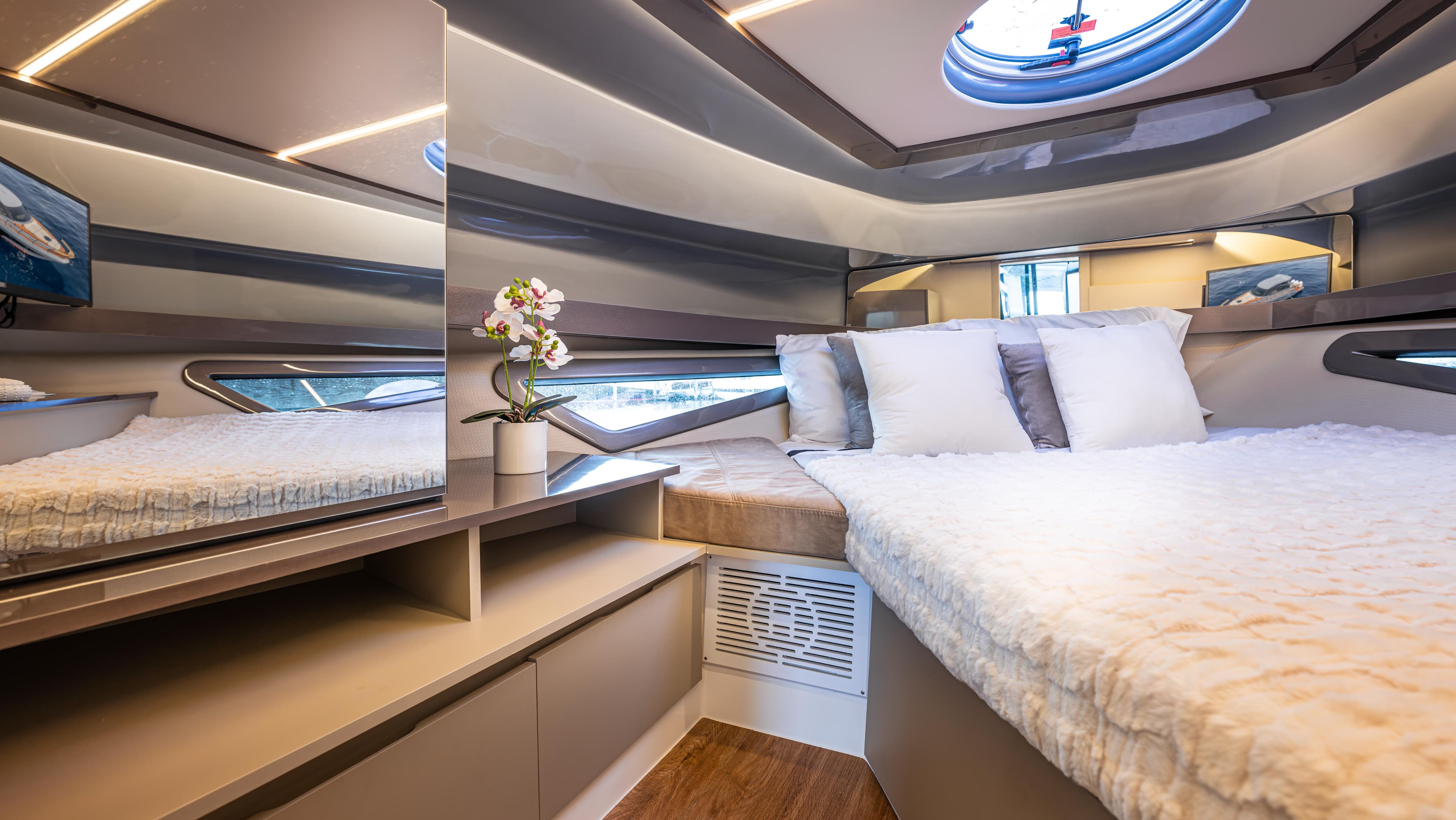 Luxurious cabin interior of 2025 Hanover 415 yacht with modern design and cozy bedding.