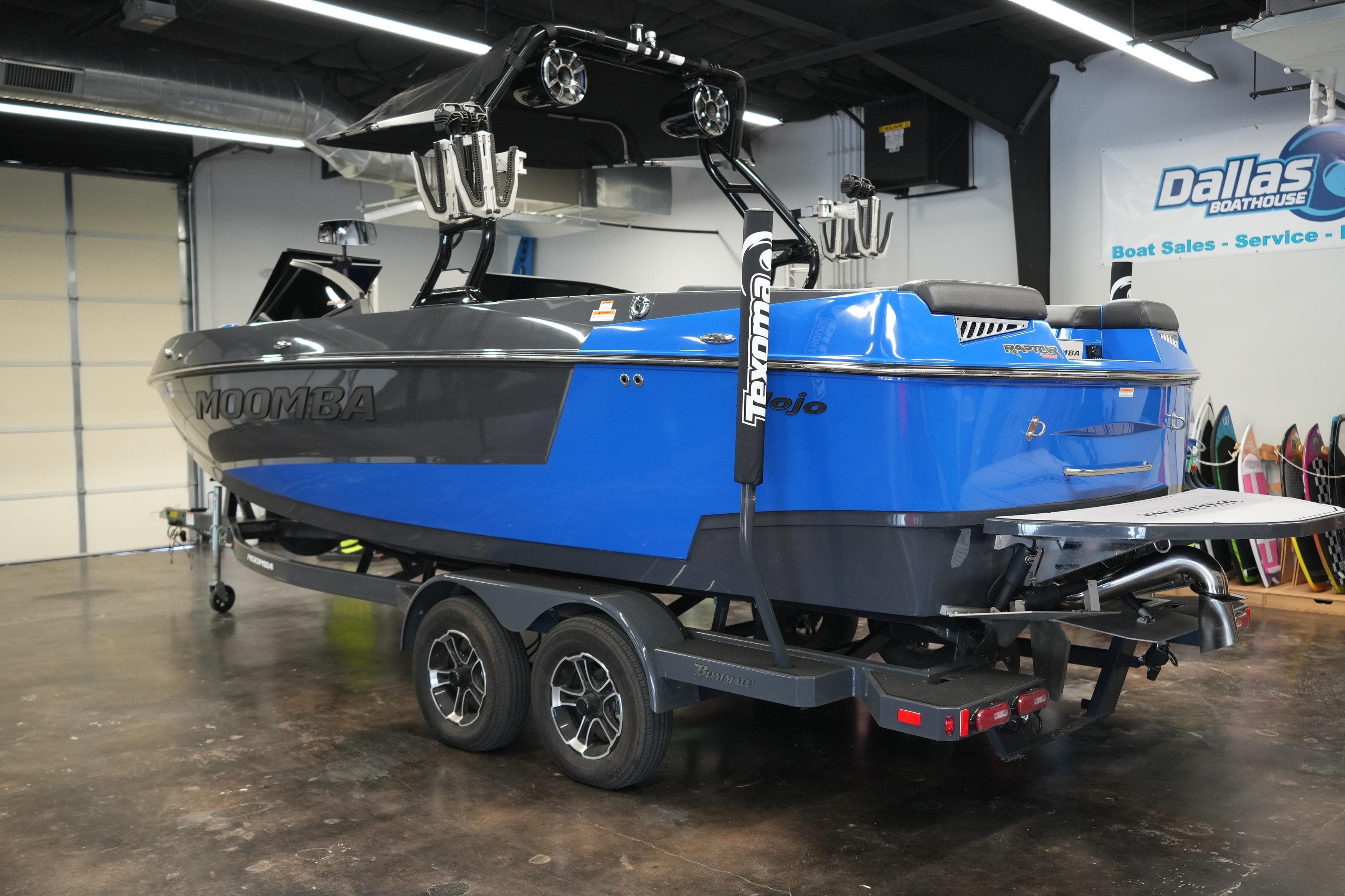 2023 Moomba Mojo boat in showroom, blue and black design, on trailer.