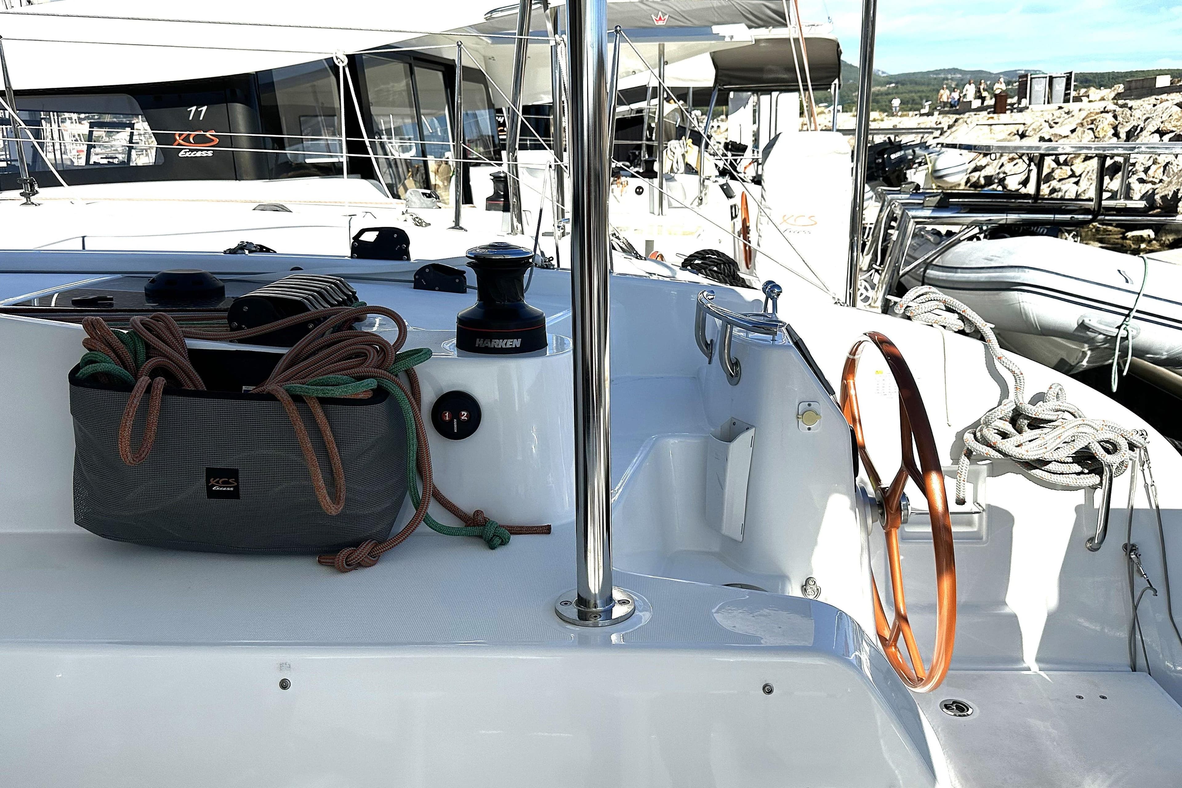 2025 Excess 11 yacht deck with ropes and winch, docked at marina.