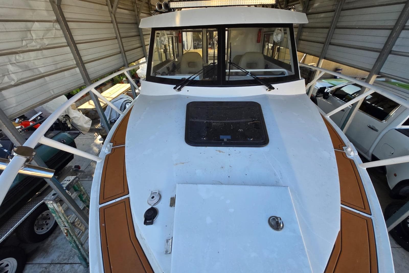 Custom Boat 34, 2025 model, docked in a covered storage area.