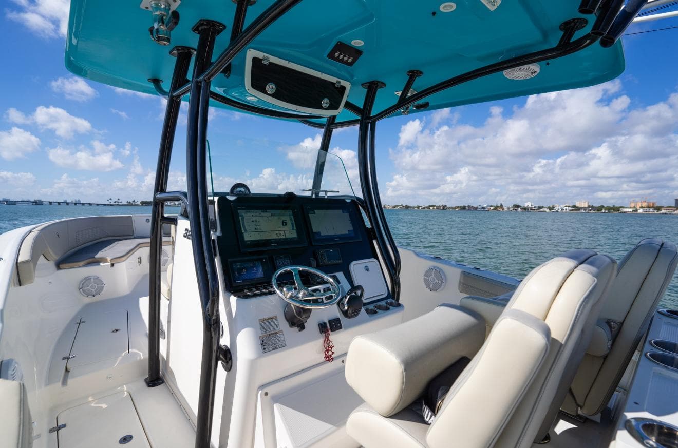 2019 Century 3200 Center Console boat interior with dual seats and navigation system on open water.