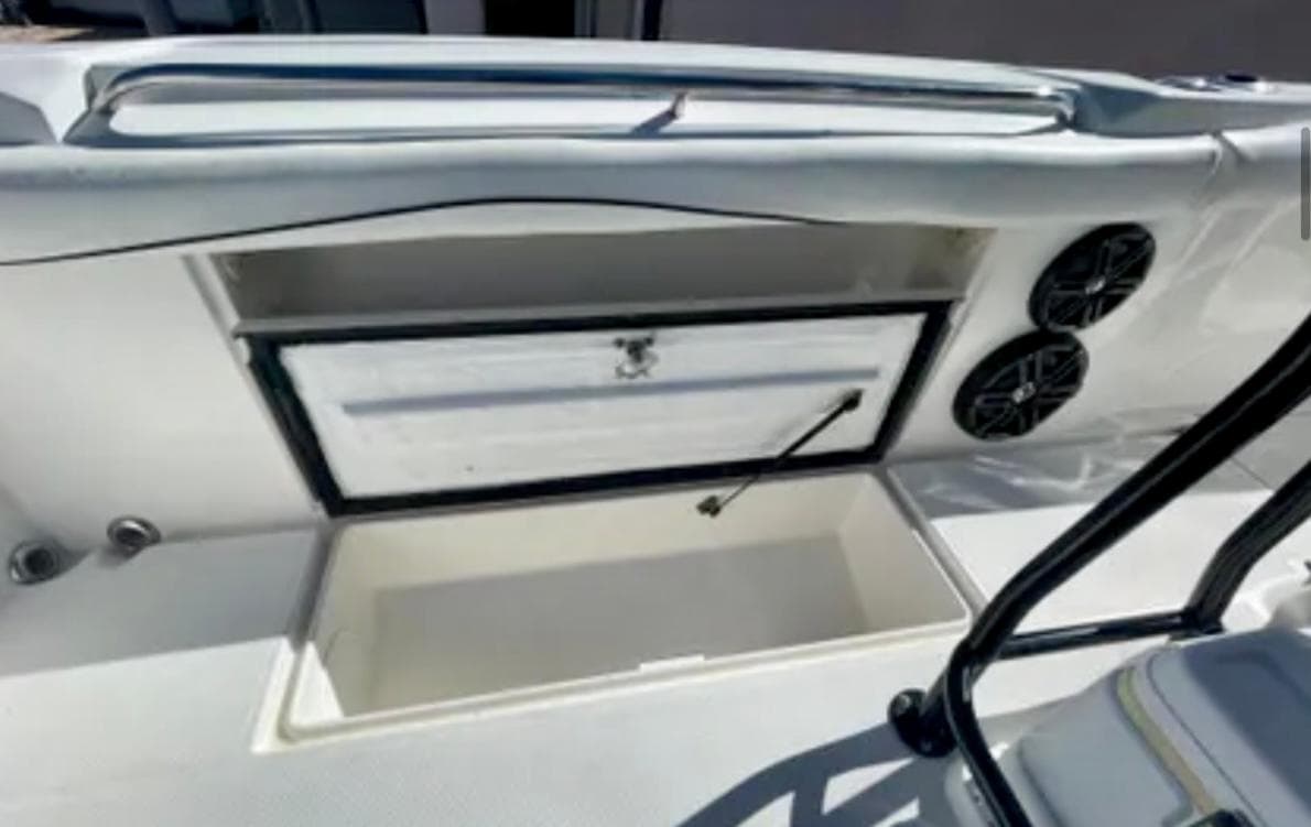 2006 Wellcraft 32 CCF boat interior with storage compartment and speakers.