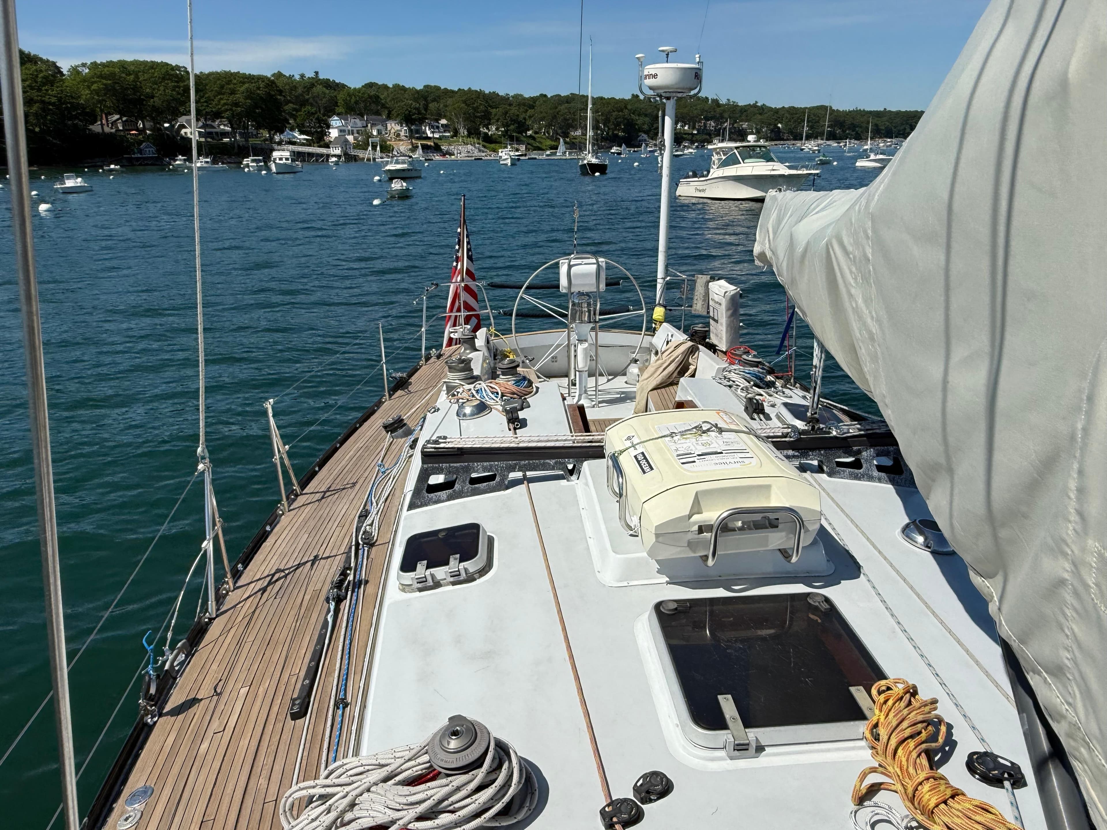 Sailboat deck view of 1986 Baltic Custom Farr 44 in a scenic harbor.