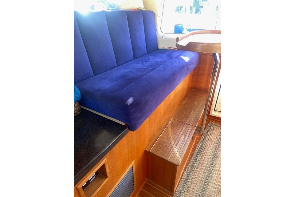 Blue cushioned seating in 2006 Nordic Tug 42 boat interior.