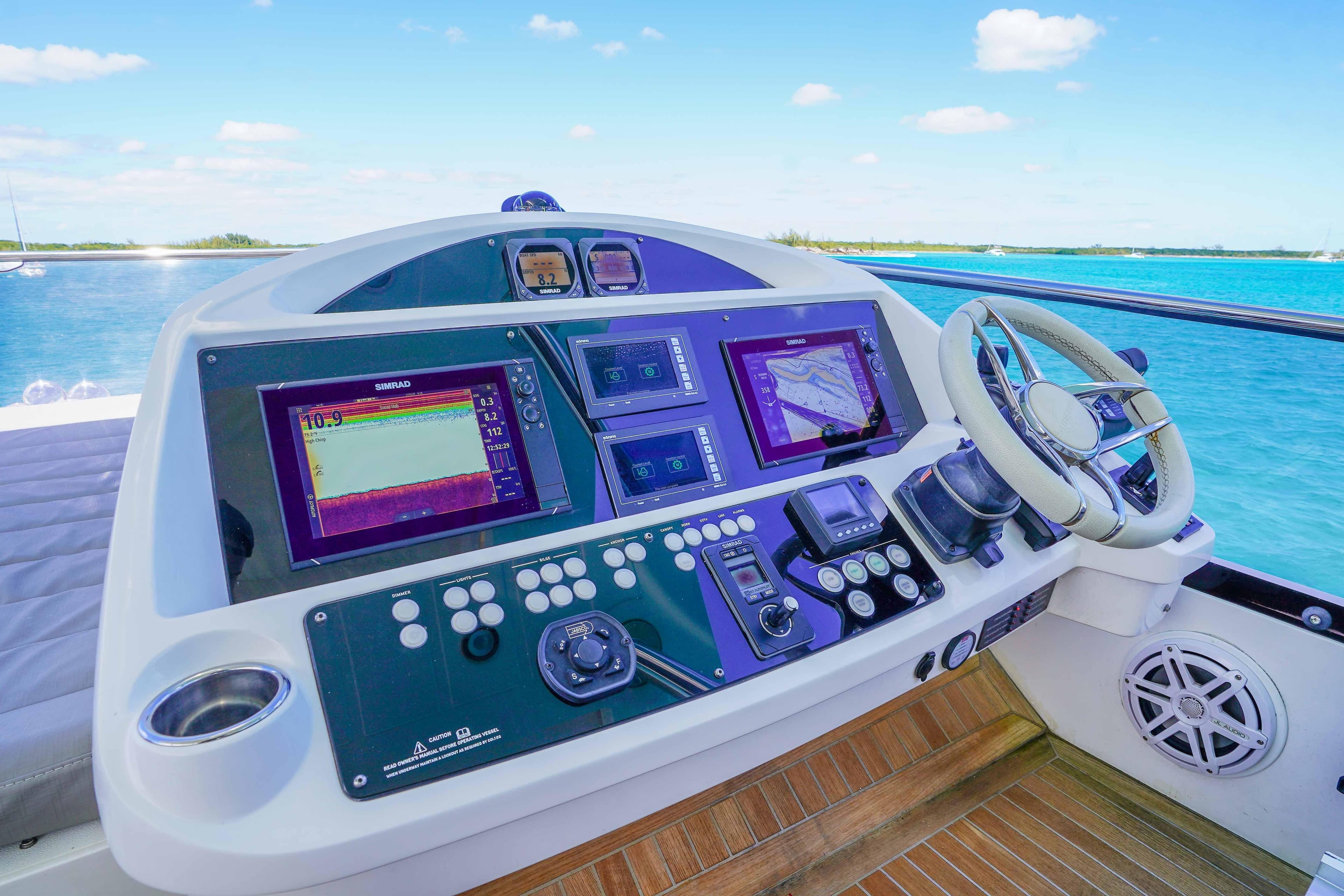 Helm of 2016 Sunseeker 75 Yacht with advanced navigation systems and ocean view.